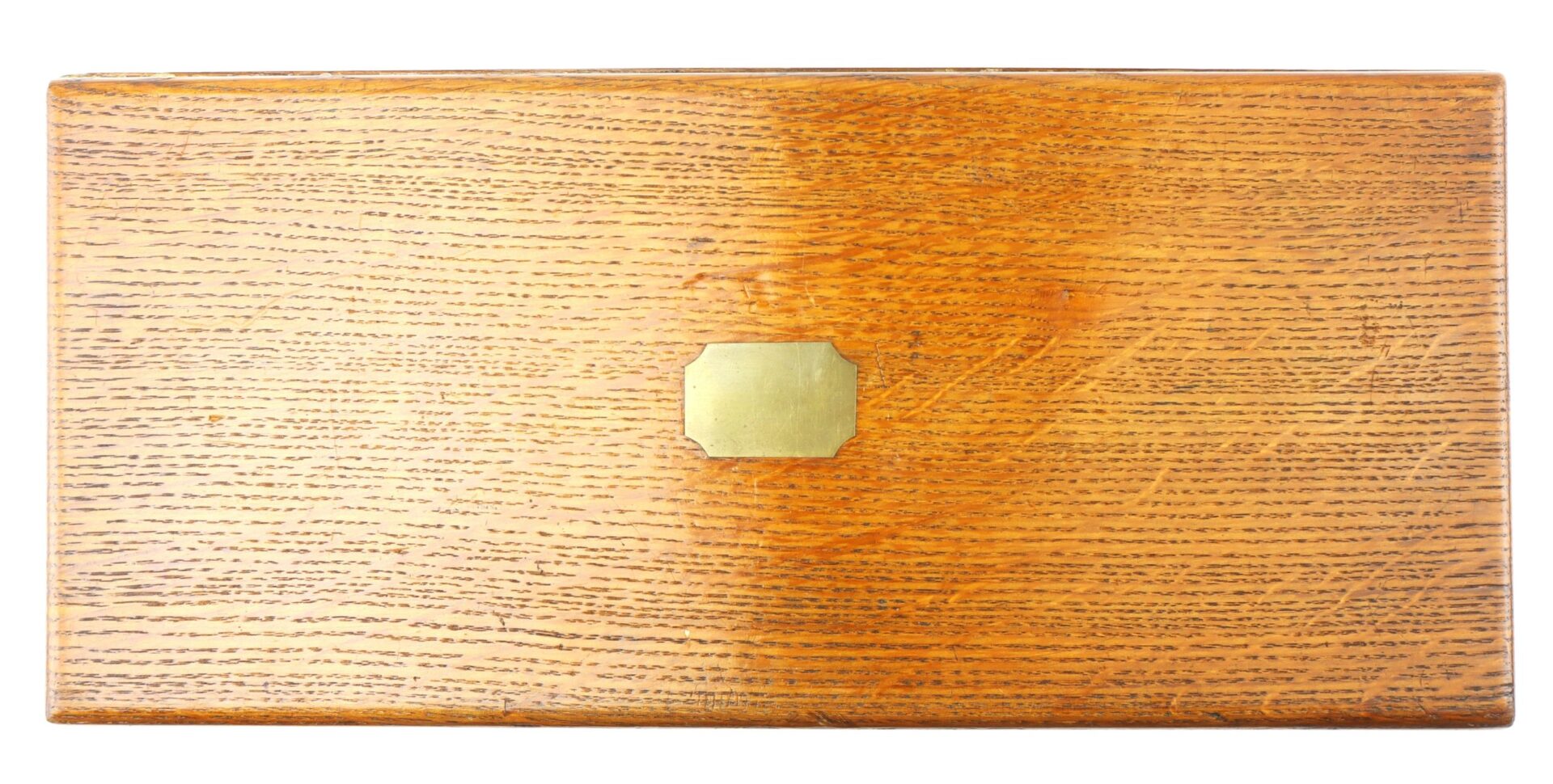 Cased High Condition London Colt 1851 Navy Percussion Revolver shown in a rectangular wooden box with visible grain and a small brass plate centered on the lid, displayed against a white background.