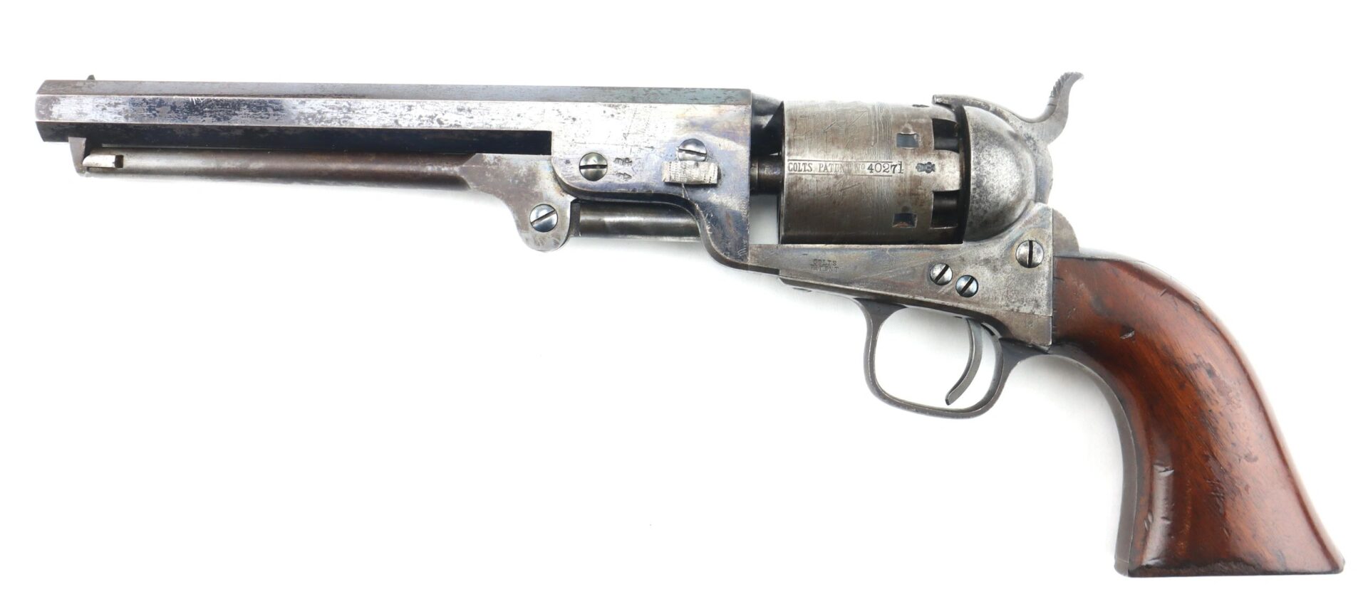 A Cased London Colt 1851 Navy Percussion Revolver with a metal barrel, cylinder, and wooden grip is displayed on a white background along with accessories.