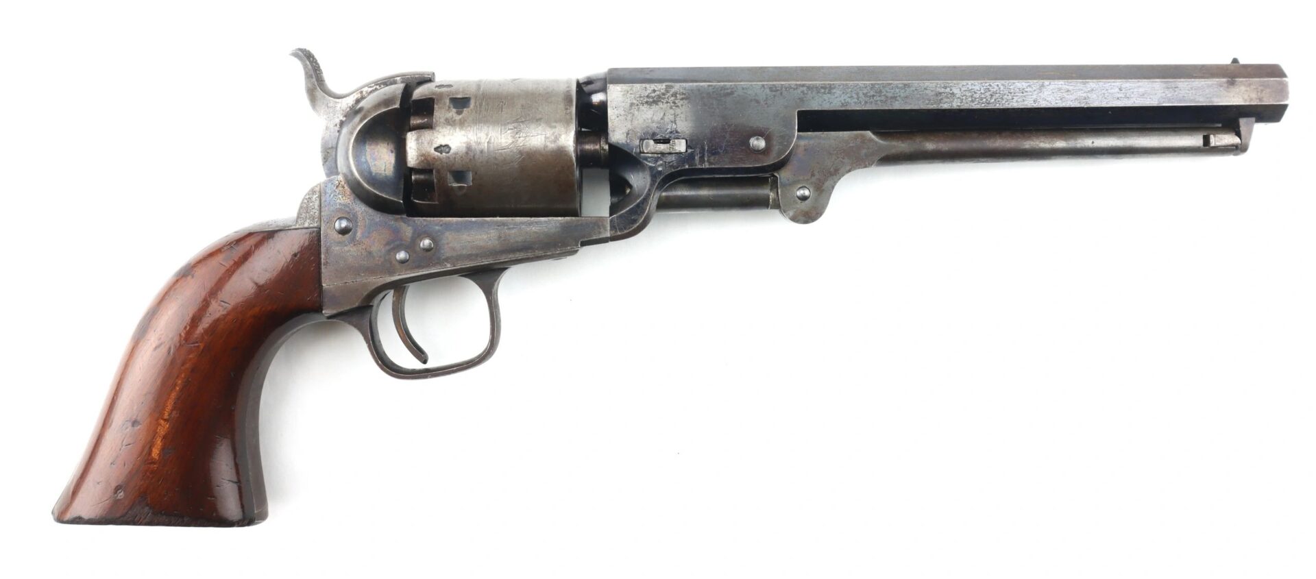 A Cased London Colt 1851 Navy Percussion Revolver with accessories, featuring a wooden handle and metal barrel, displayed in right-side profile against a white background.
