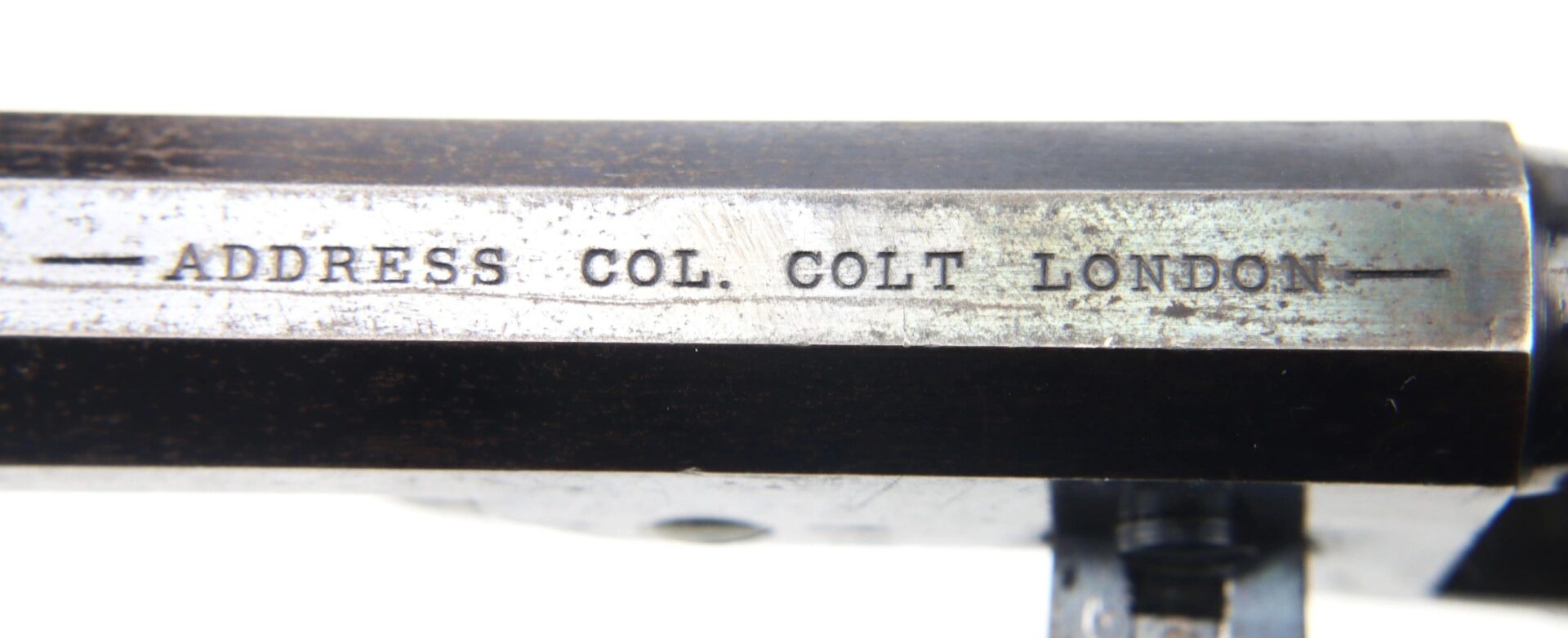 Close-up of the metal barrel on a Cased London Colt 1851 Navy Percussion Revolver engraved with: "-- ADDRESS. COL. COLT. LONDON --".