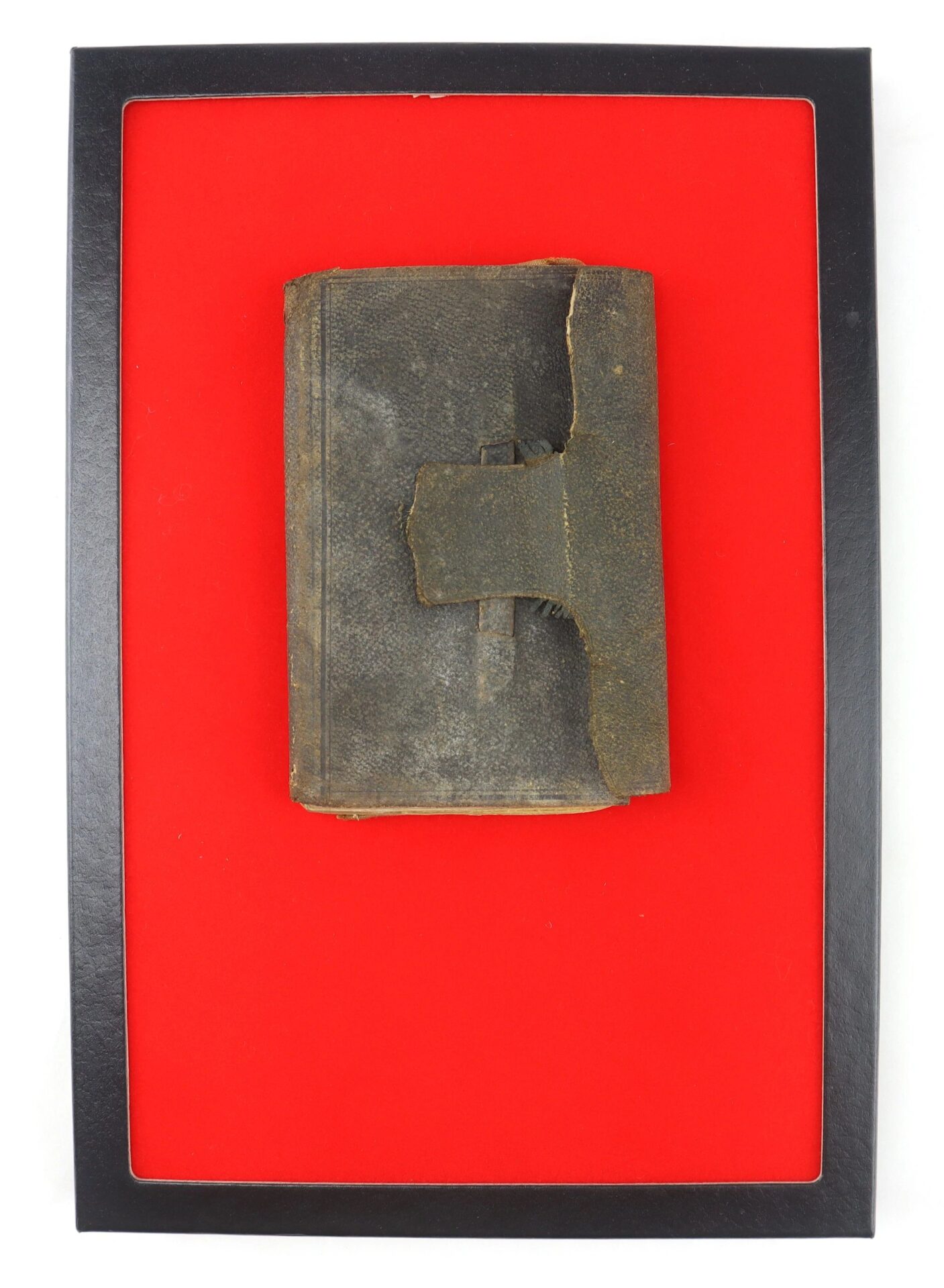 The Confederate Officer’s Ledger of Lieut. Tho. W. Martin (Co. H, 10th VA Cavalry, 4th Brigade, Feb 10th 1863 / SOLD), a worn dark leather-bound book with a broken strap, is displayed against a bright red background in a black frame.
