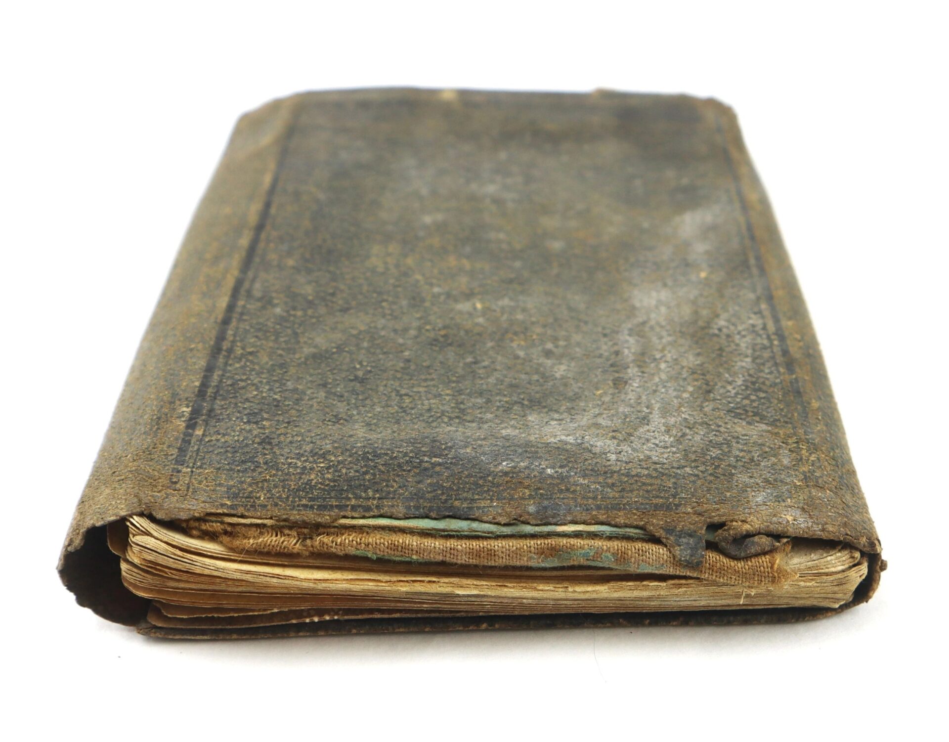 A worn Confederate Officer’s Ledger (Lieut. Tho. W. Martin – Co. H, 10th VA Cavalry, 4th Brigade, Feb 10th 1863) with a faded dark cover and yellowed frayed pages lies closed and flat on a white background.