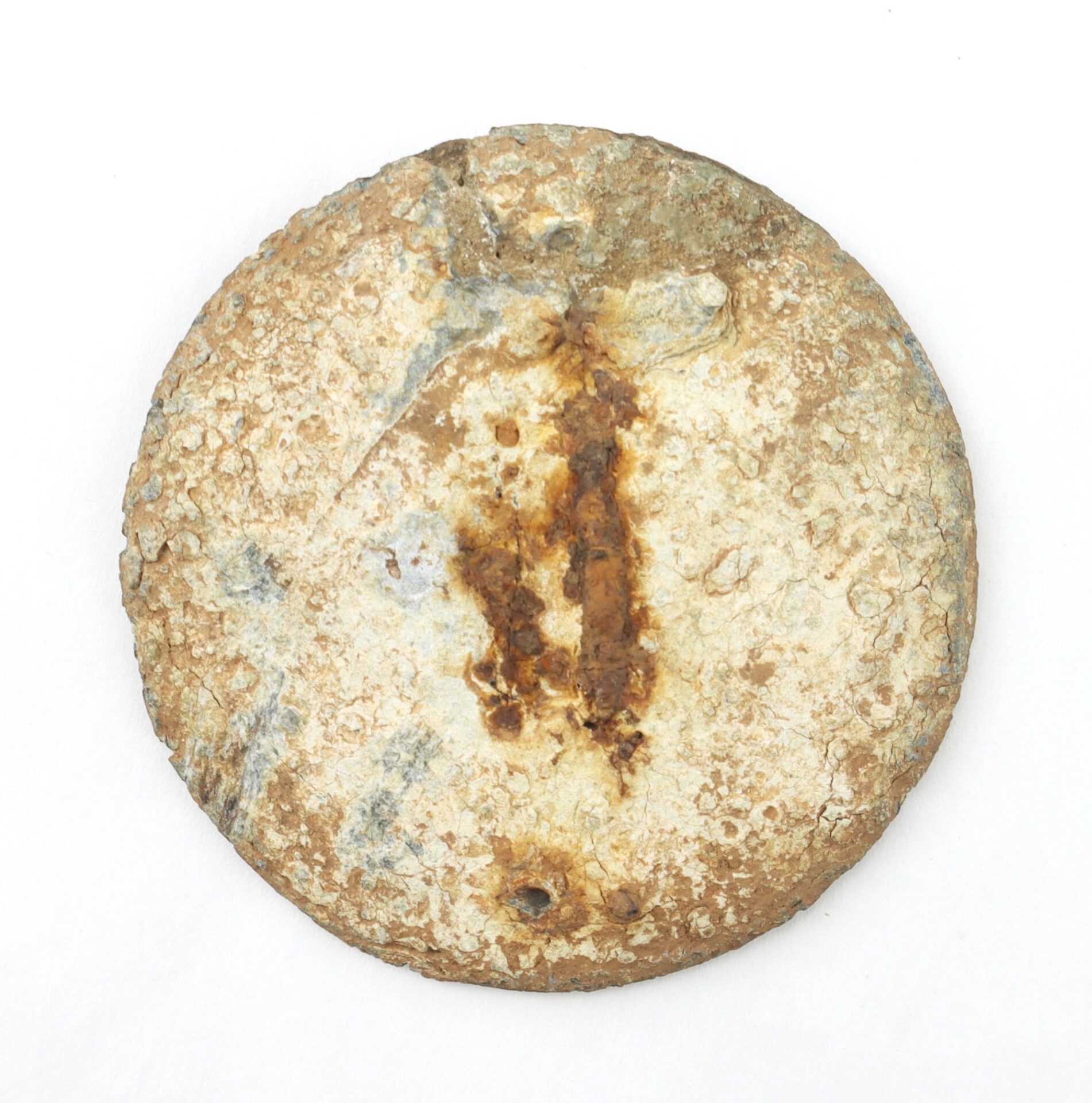 The Gettysburg Eagle Breast Plate, a round metal artifact with significant rust and corrosion, is displayed on a plain white background.