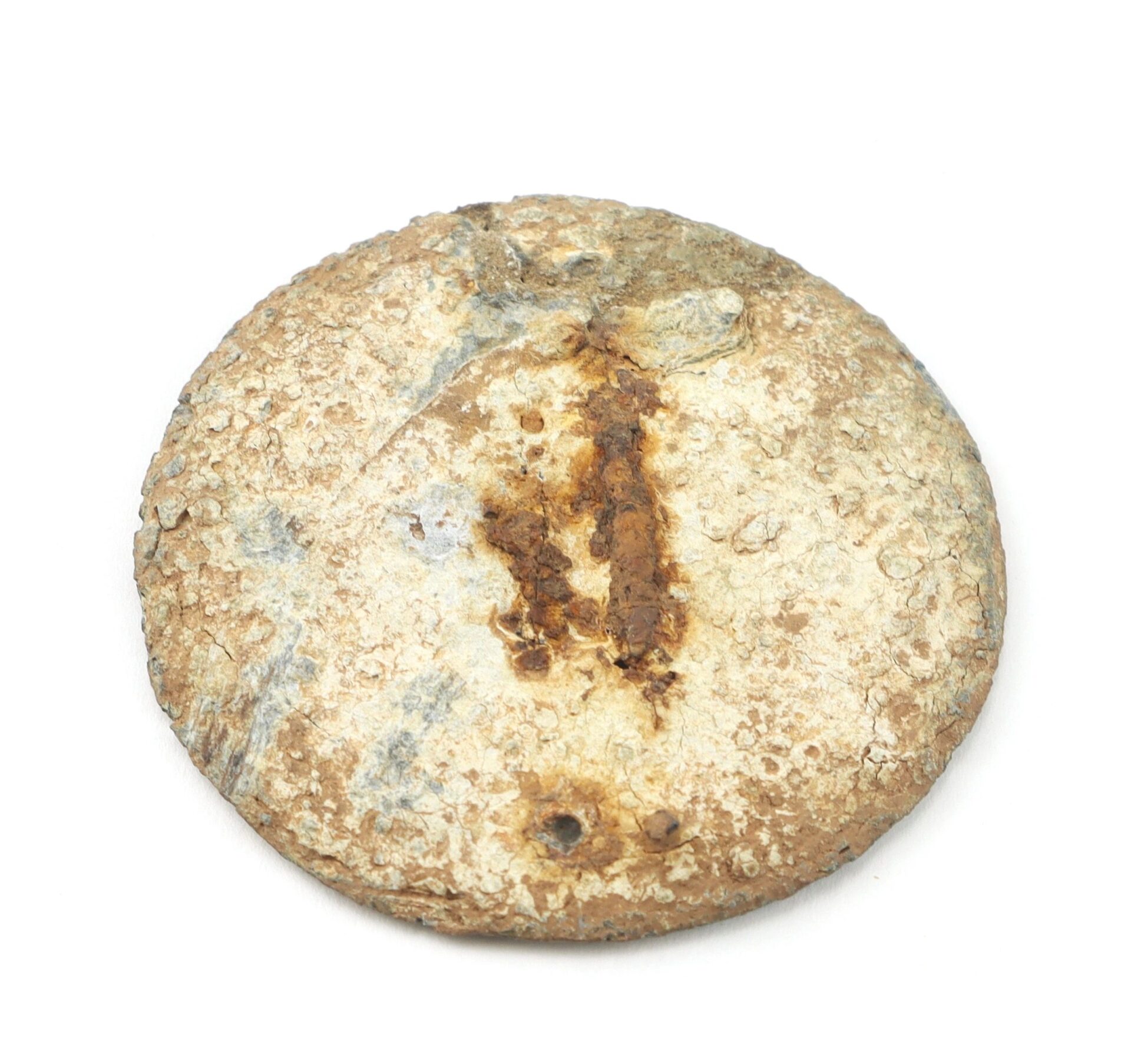 A weathered Gettysburg Eagle Breast Plate with rust and corrosion spots on its round, flat metal surface, displayed against a white background.