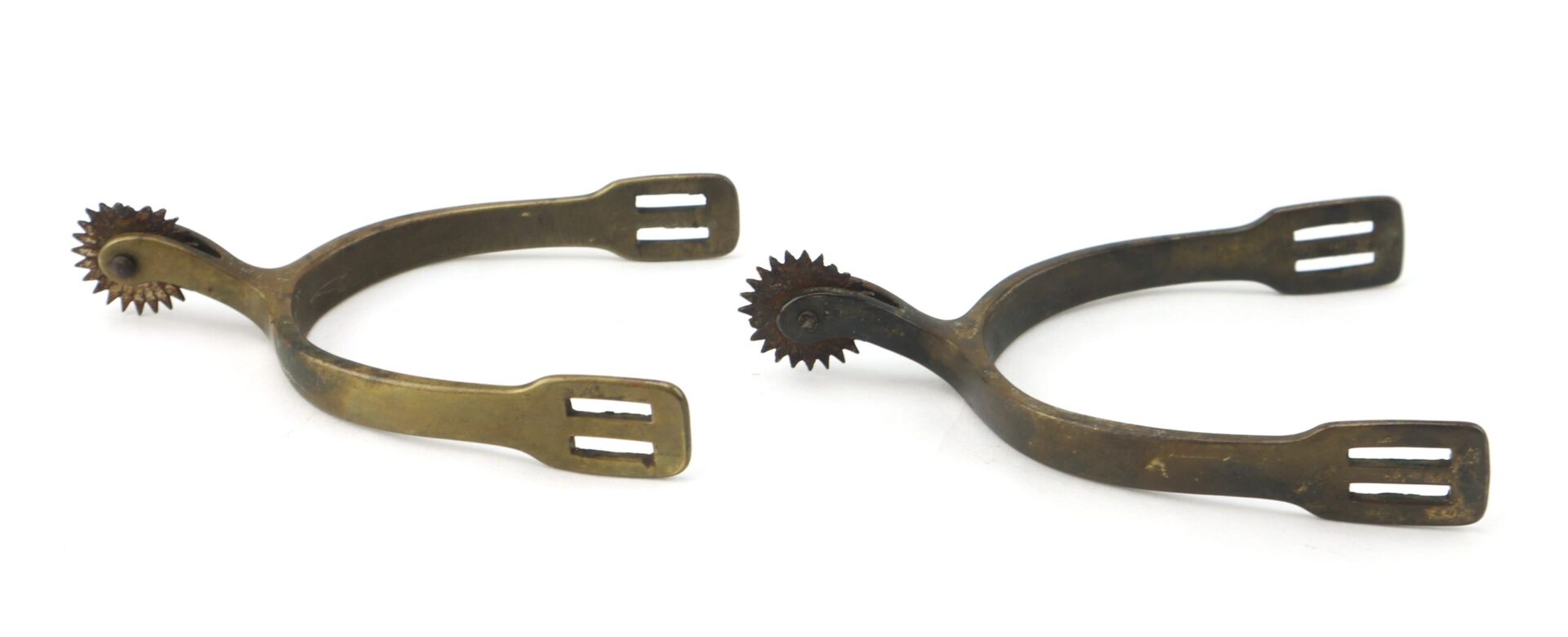 A pair of Civil War Spurs made of antique brass with rowels and rectangular strap slots, displayed on a white background.