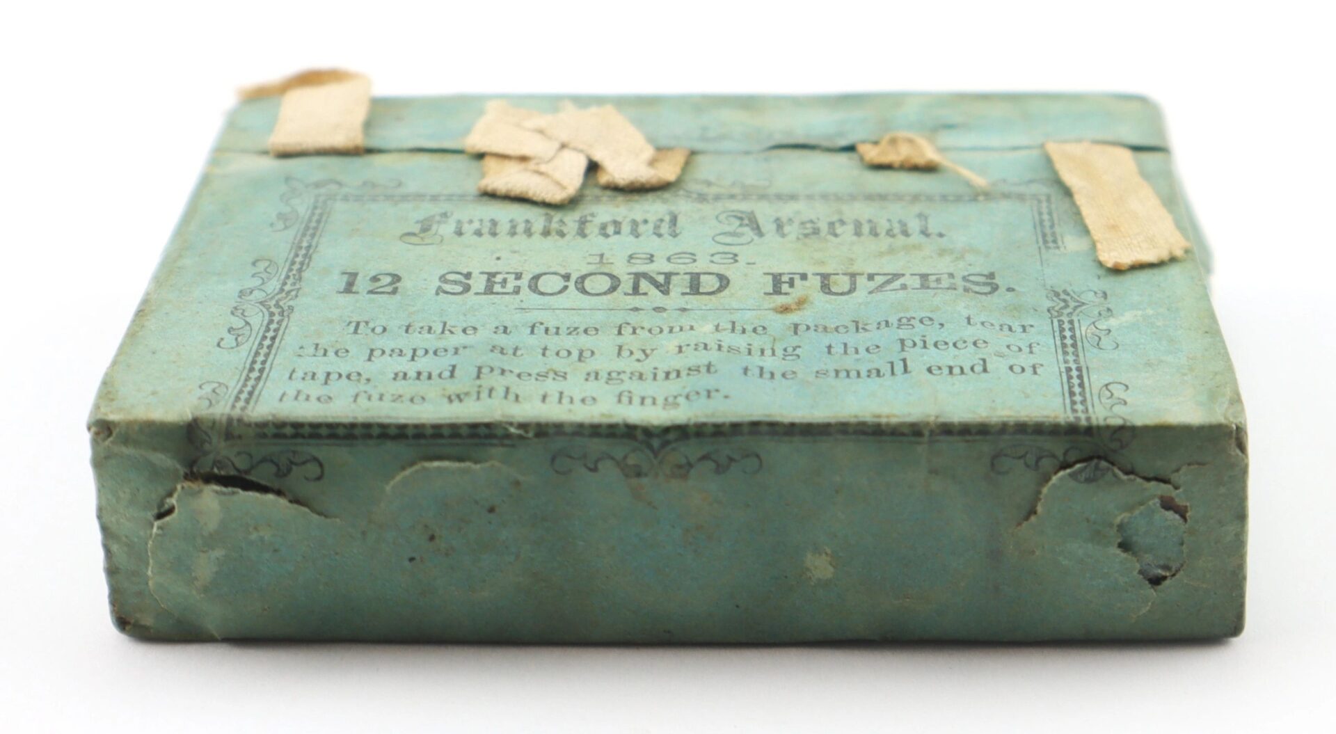 A vintage Frankford Arsenal 12 Second Fuses blue box with worn corners and faded tape on top.