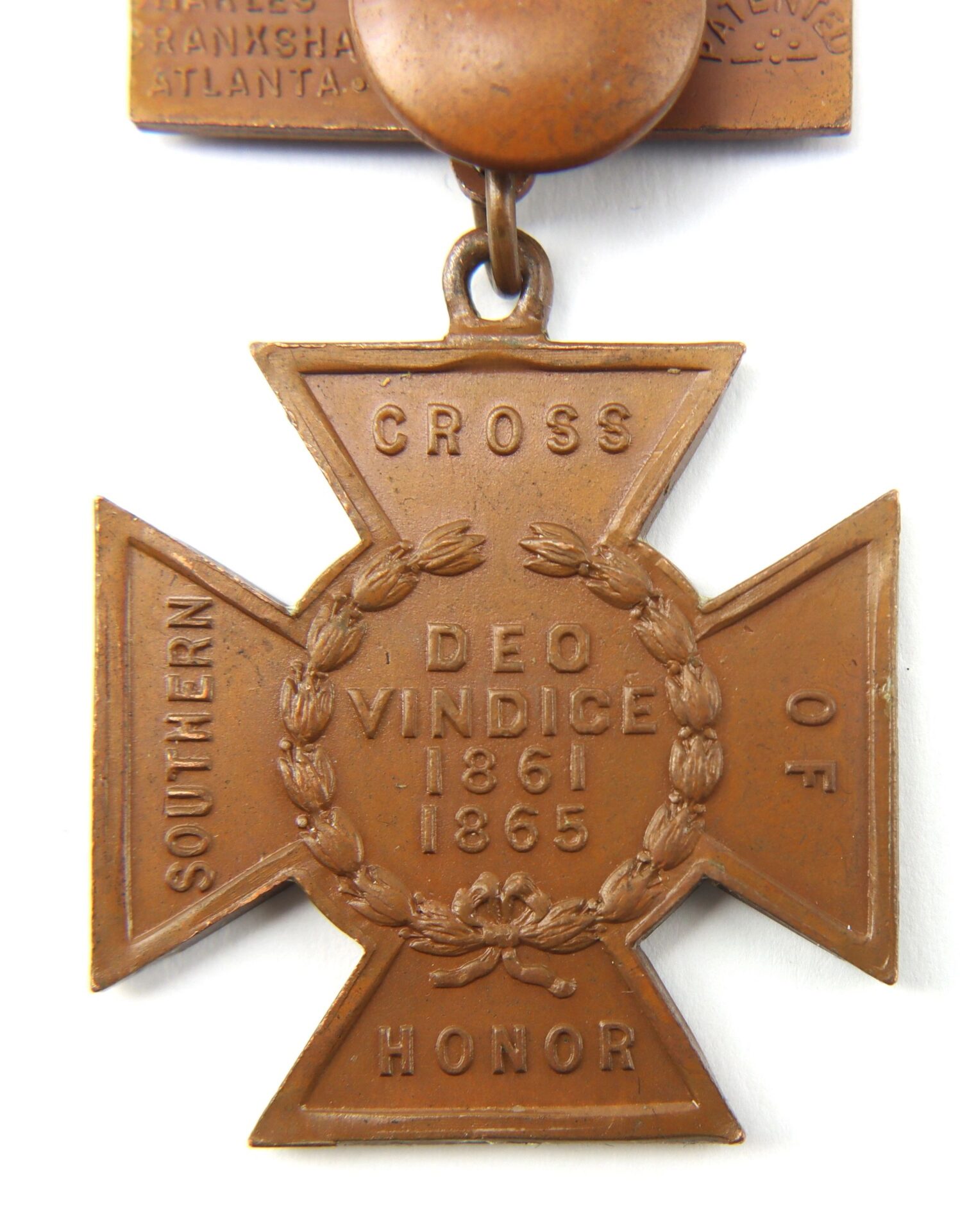 A bronze cross-shaped "Southern Cross of Honor" medal inscribed with "Deo Vindice 1861 1865" and a laurel wreath, awarded to Captain J.A.W. Thomas, Co. F, 21st South Carolina Infantry—twice wounded Confederate officer.
