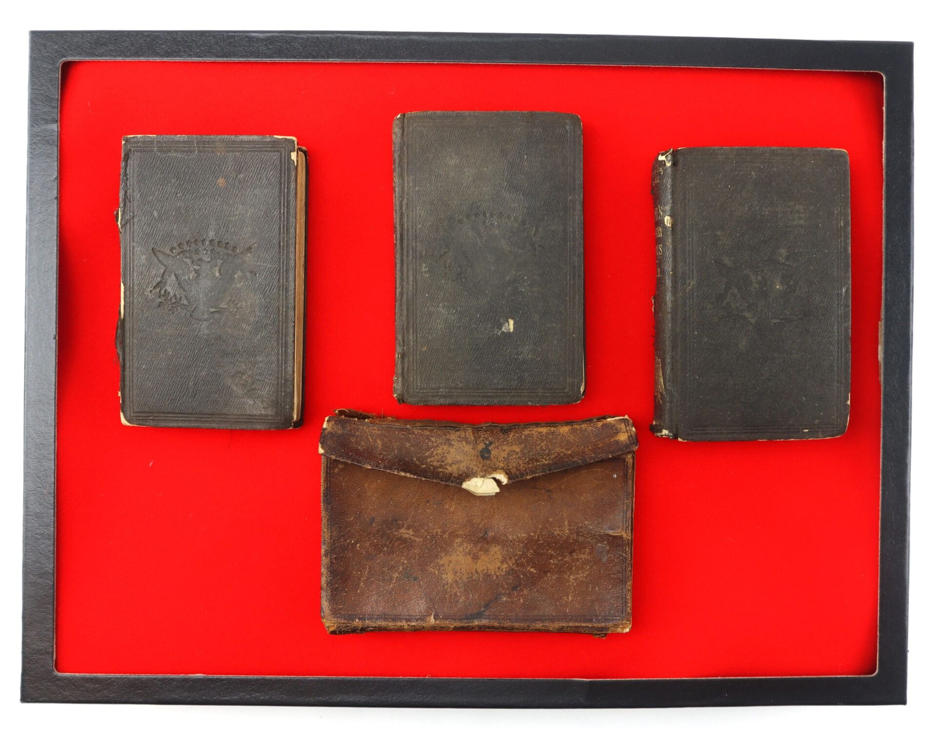 The 10th Tennessee Volunteer Infantry (Union) Grouping features three worn antique hardcover books and a brown leather pouch, all displayed on red within a black frame.