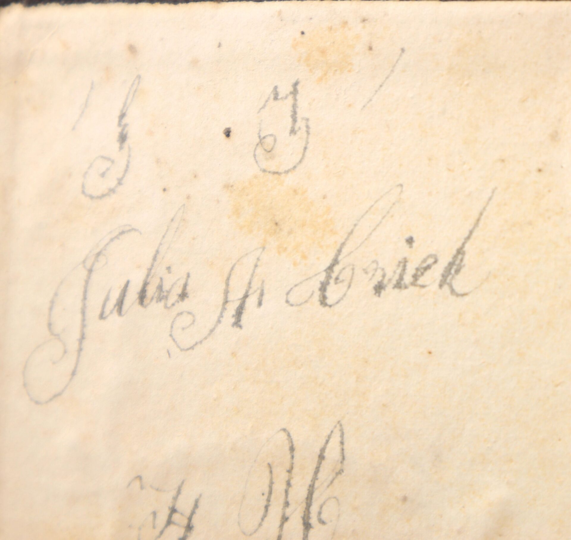 Close-up of aged paper with cursive "Julius H. Aviehl" in faded ink, associated with the 10th Tennessee Volunteer Infantry (Union) Grouping.