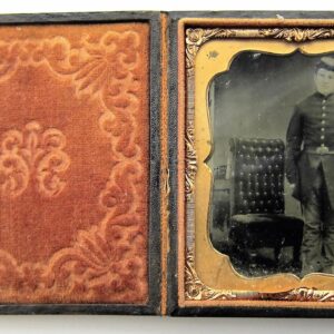 A tintype photograph titled “Infantryman with Springfield Rifle-Musket Sixth Plate” shows a man in military uniform beside a chair, housed in an ornate case with velvet lining and a gold-colored frame.