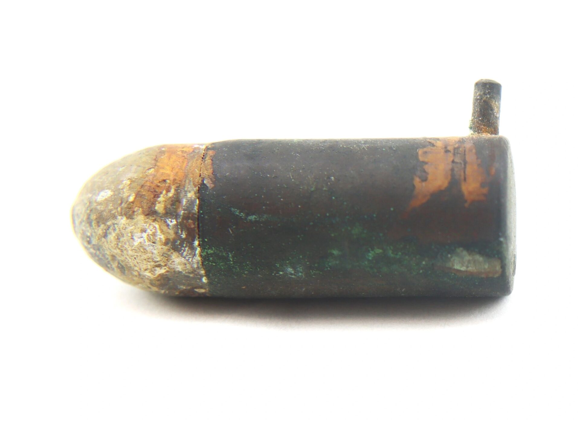 A Confederate Lafanceaux 12M/M French Pin Fire Cartridge, showing corrosion and rust with a small protruding pin, displayed on a white background.