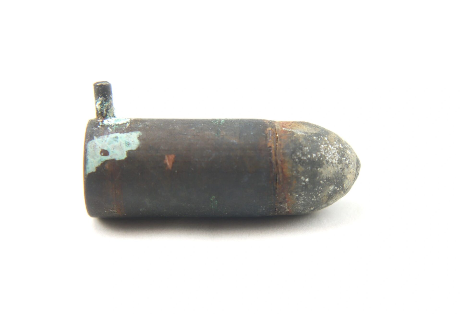 A Confederate Lafanceaux 12M/M French Pin Fire Cartridge, a cylindrical metal object with a small protruding pipe, rests on a white background.