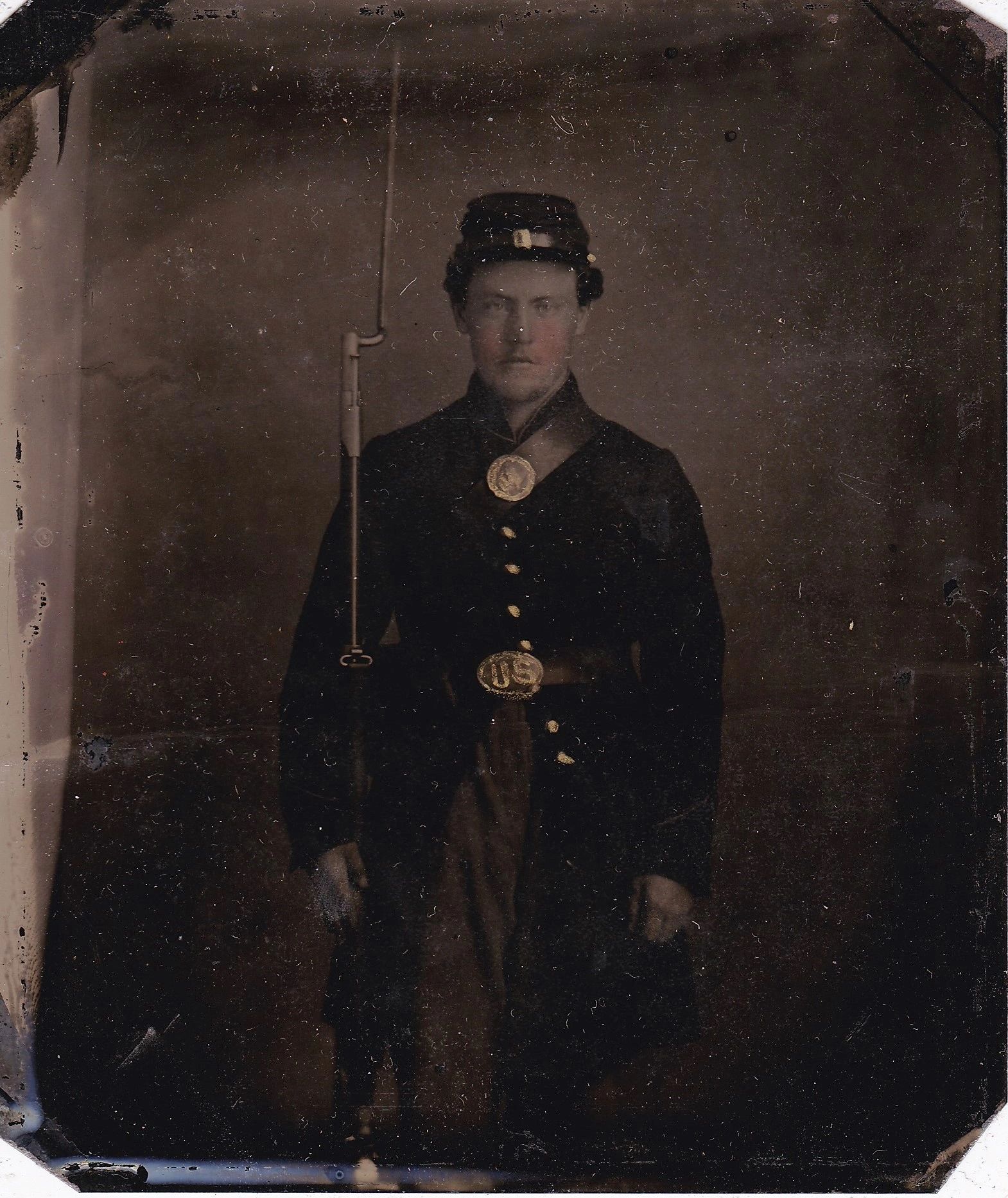 The "Soldier with Model 1816 Musket Sixth Plate Tintype" shows a young Civil War-era soldier in uniform, wearing a kepi hat, holding his rifle, and displaying a "U.S." belt buckle as he poses for a portrait.