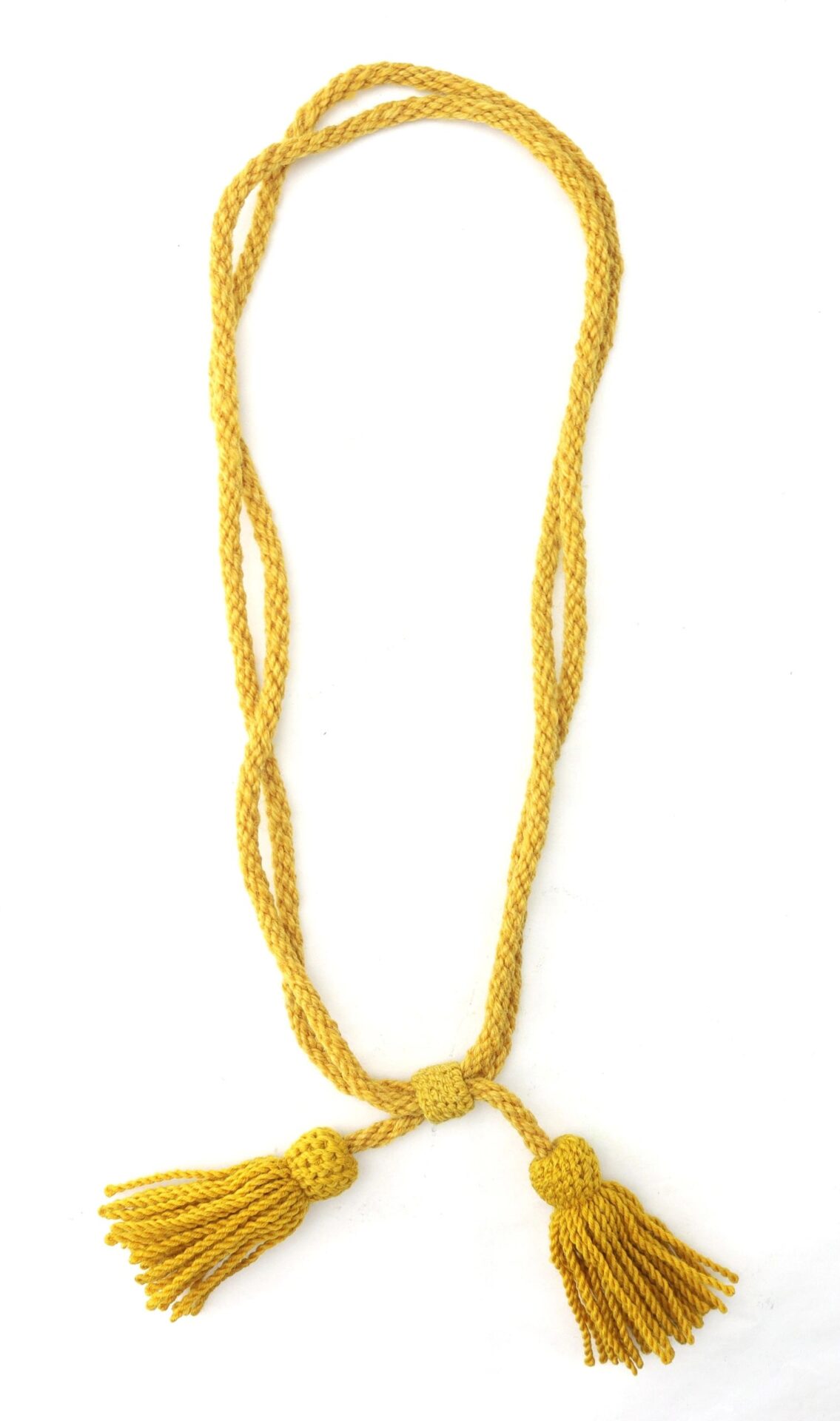A Cavalry Hardee Hat Cord, long and yellow with two large tassels at each end, is shown loosely braided in an oval on a white background.