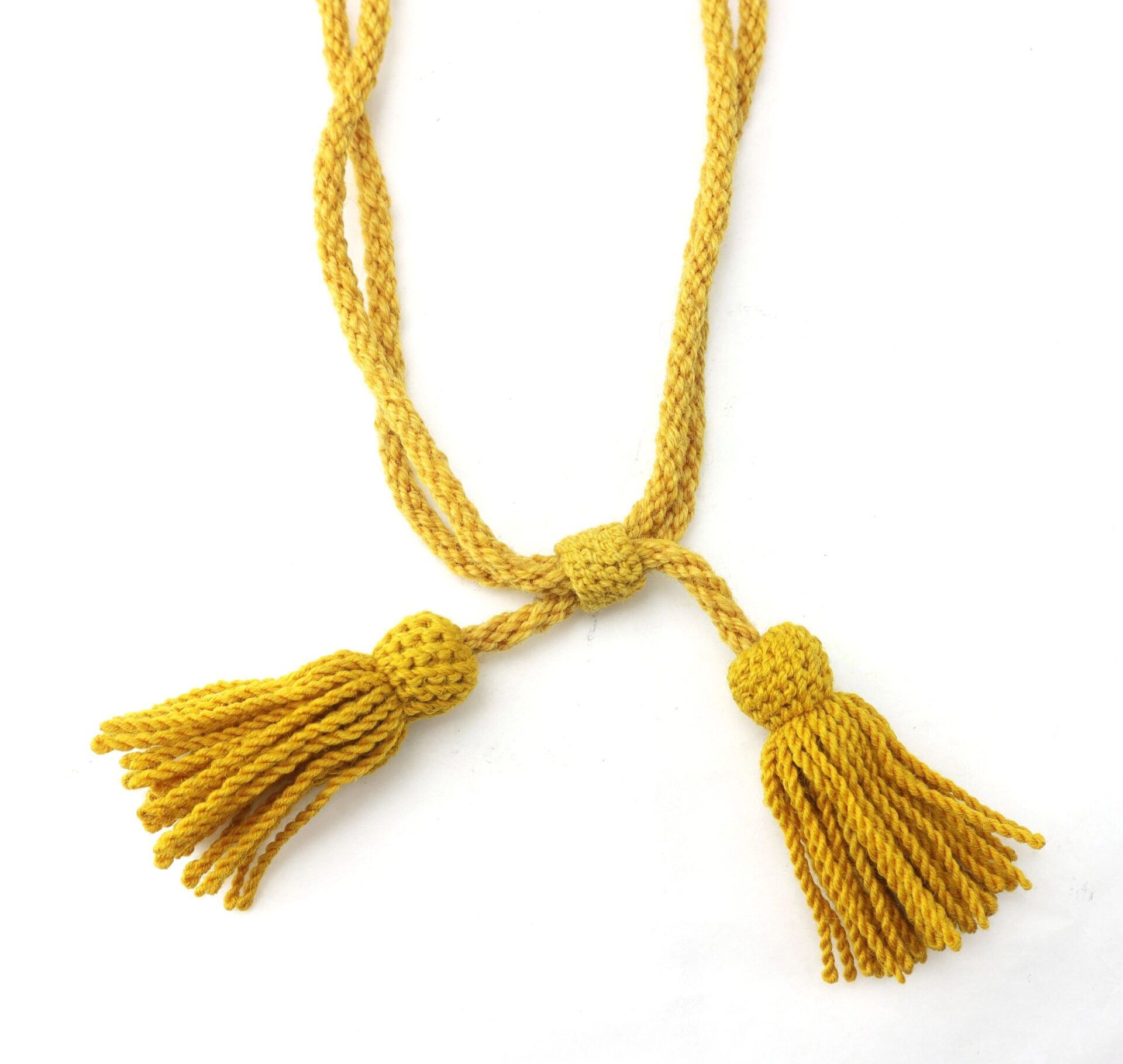 A Cavalry Hardee Hat Cord, yellow and braided with two tassels at the ends, is shown on a white background.