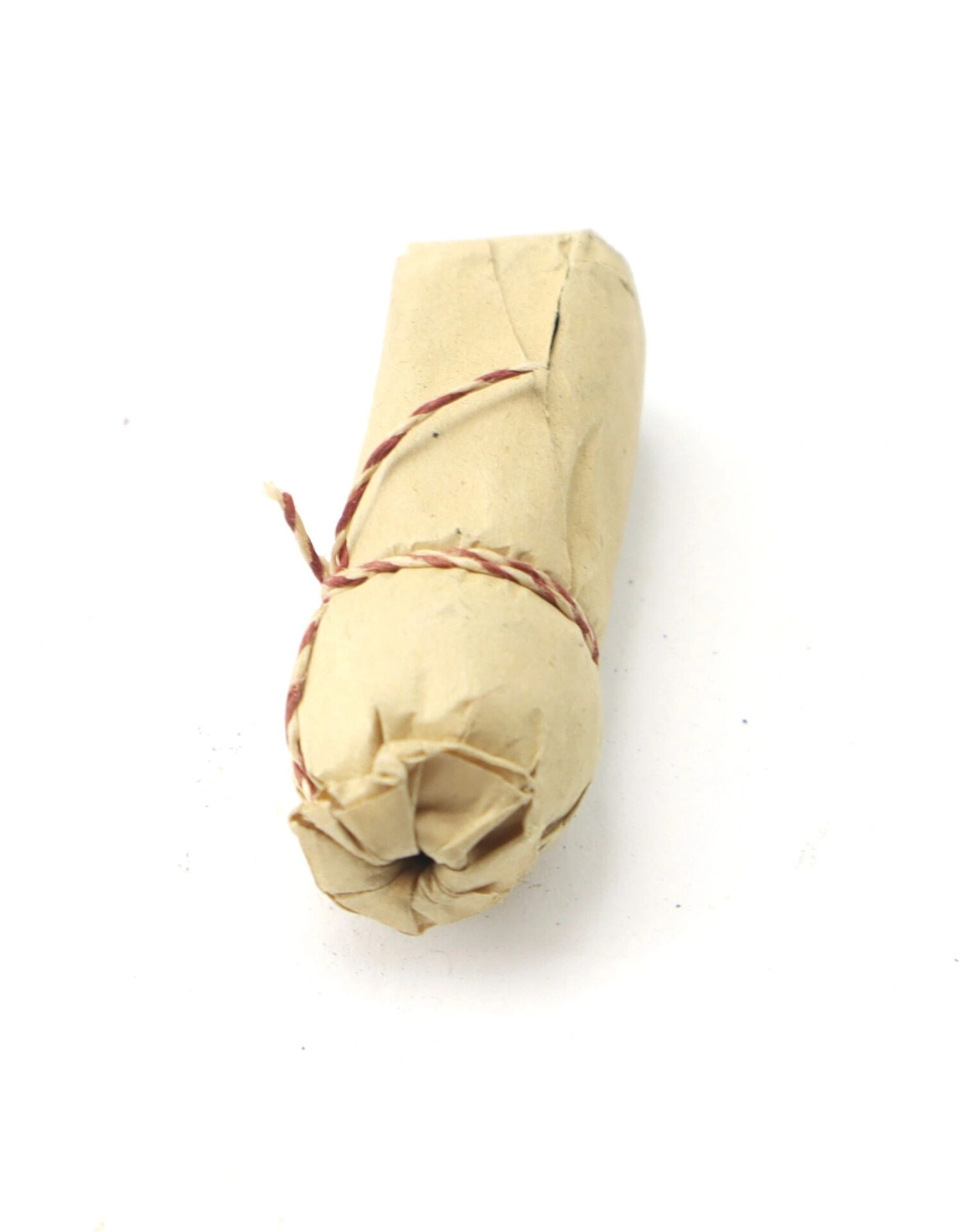 A .69 Caliber Hall Carbine Cartridge, wrapped in brown paper and tied with twine, displayed on a plain white background.