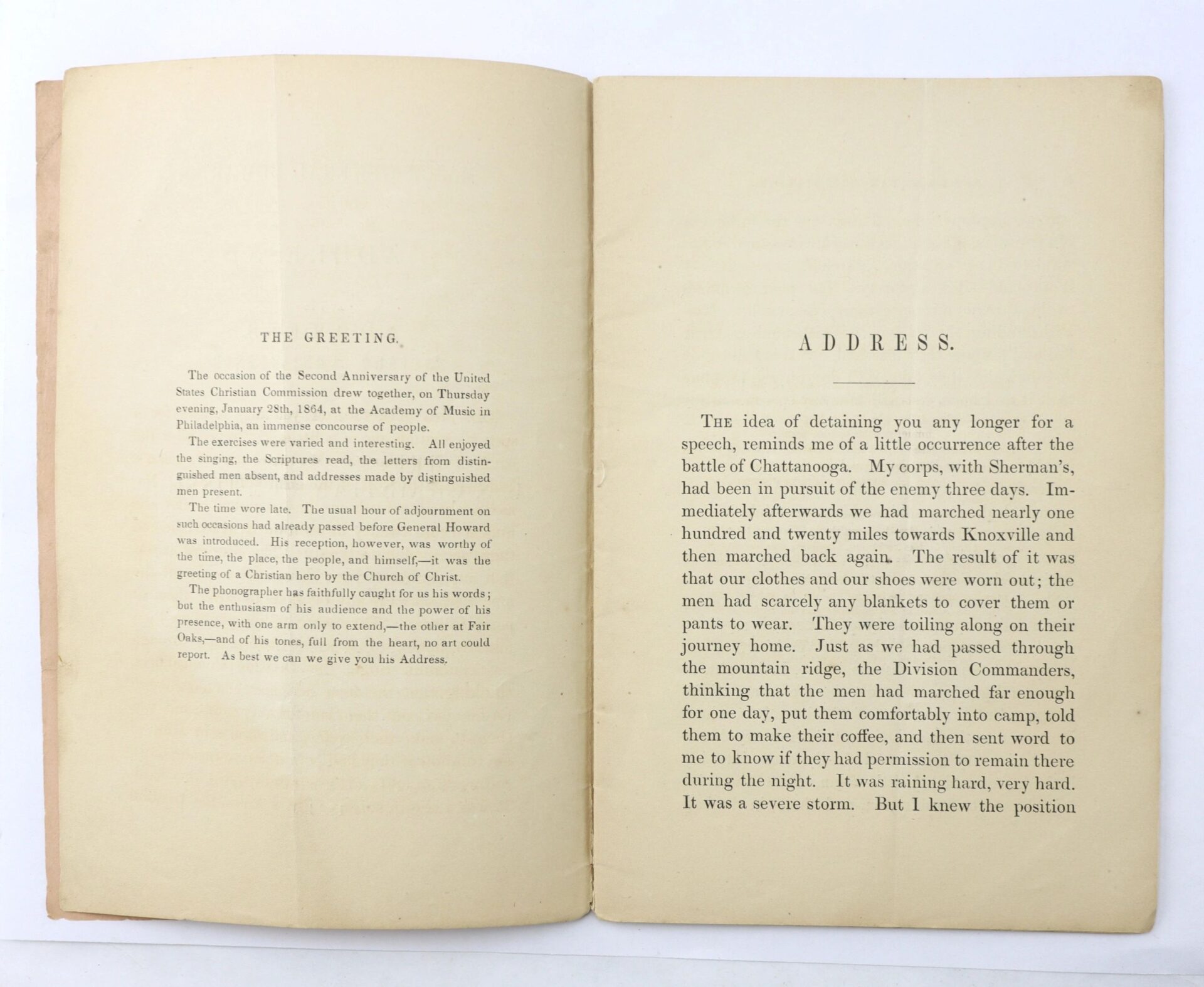 An open book titled "U.S. Christian Commission" shows two pages: the left page, "THE GREETING," and the right, "ADDRESS," both featuring printed English text.