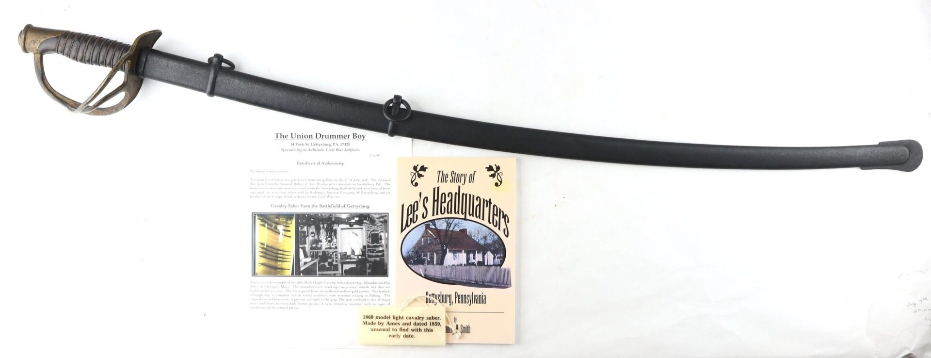 A Gettysburg Cavalry Saber (SOLD) in a scabbard displayed above two historical documents and a book titled "The Story of Lee's Headquarters.