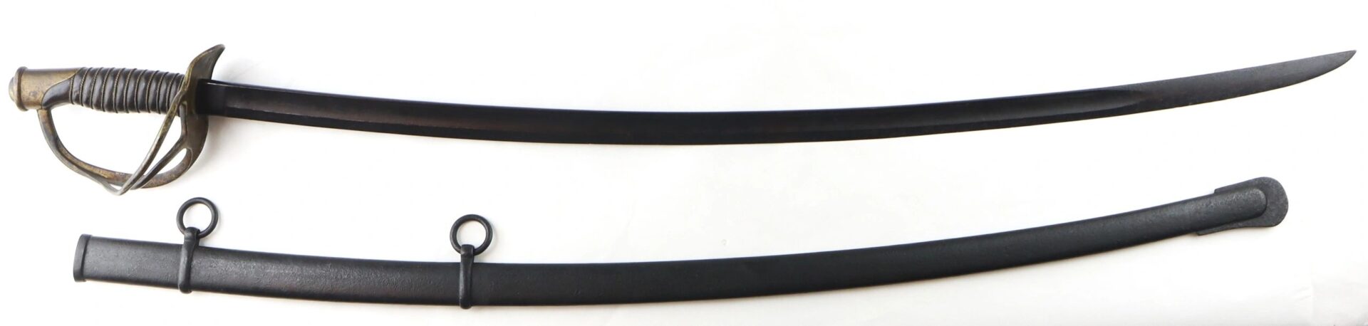The Gettysburg Cavalry Saber with its guard rests beside the matching black scabbard, both displayed on a white background.