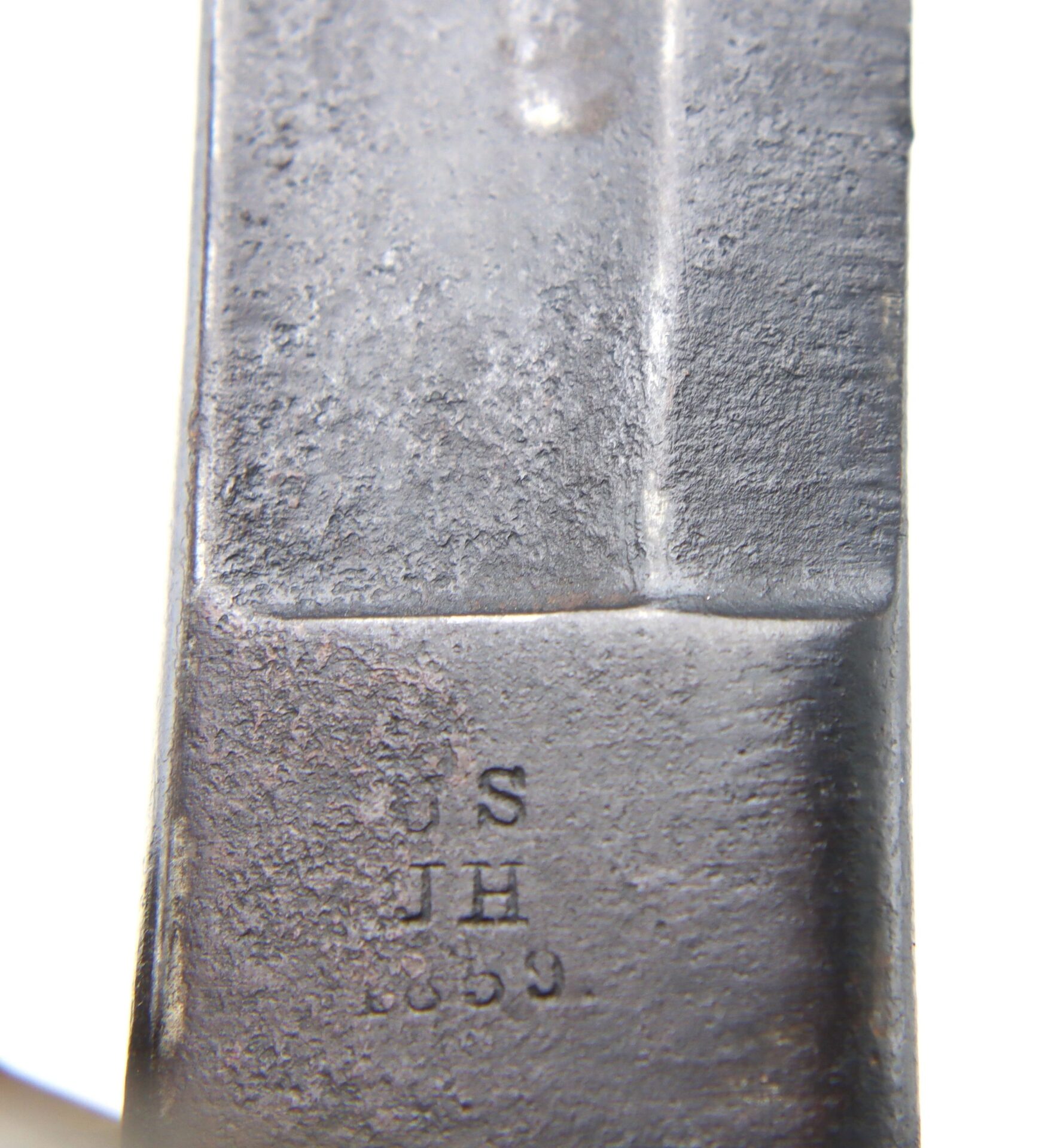 Close-up of the Gettysburg Cavalry Saber’s metal surface, stamped with “US JH 1859.”.
