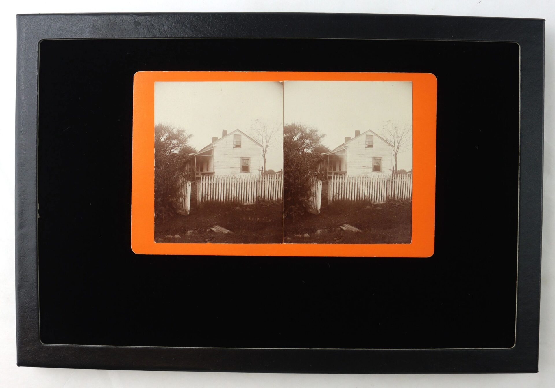 A stereoview titled "General Meade’s Headquarters at Gettysburg" shows a two-story house with a white picket fence and trees, mounted on an orange-bordered card with a black frame.