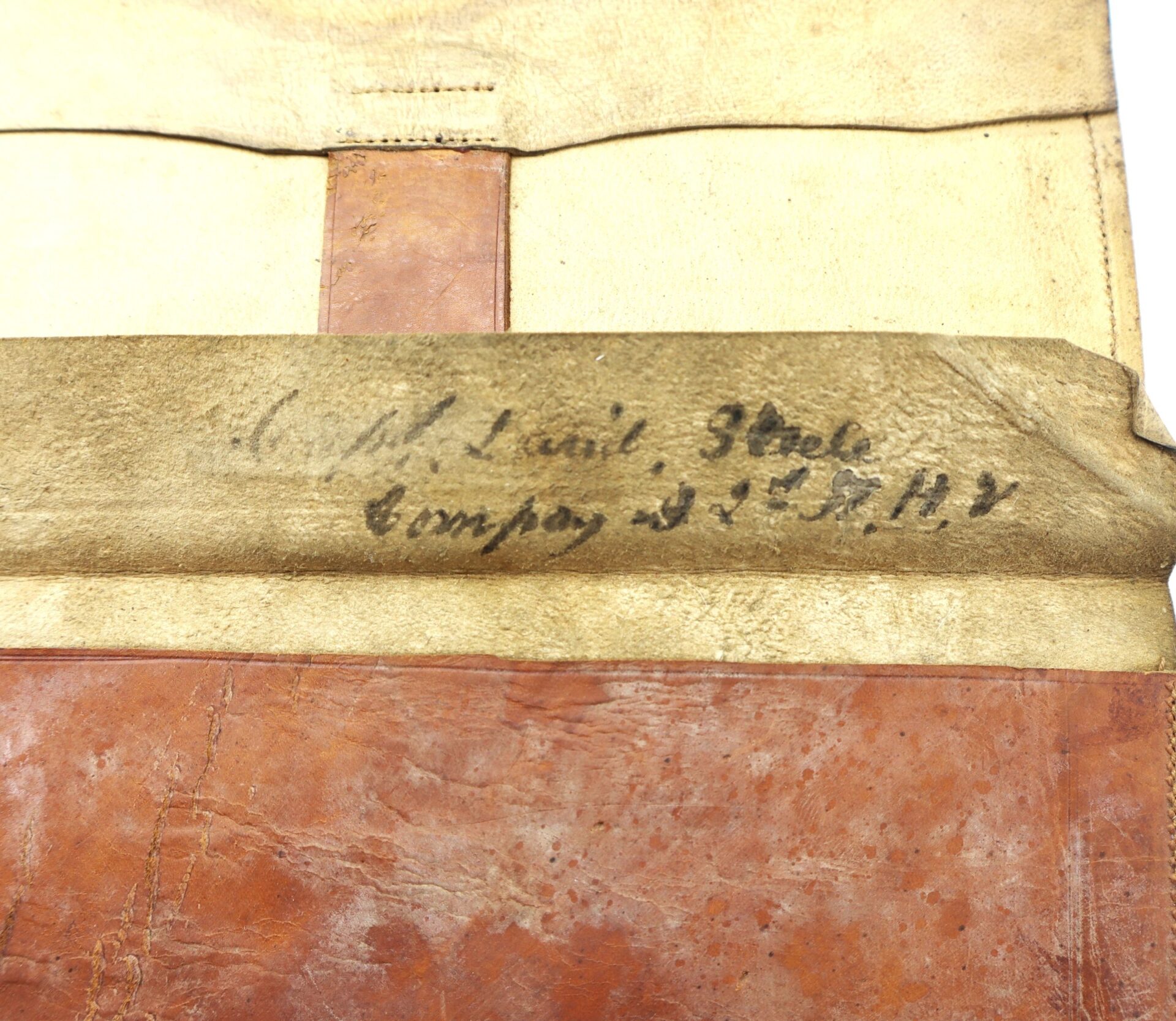 A close-up of the Inscribed Wallet of Corporal David Steele, 2nd New Hampshire Infantry, featuring worn leather and handwritten text.