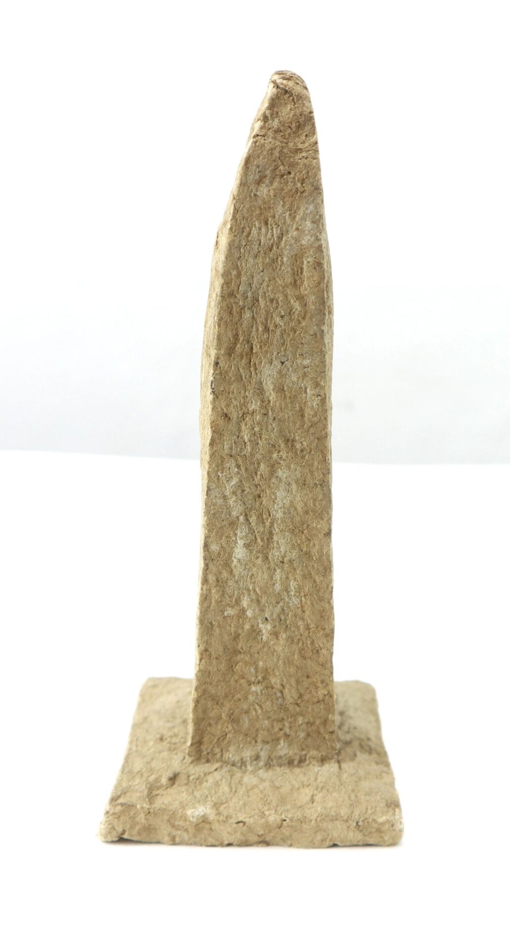 A vertical, rectangular Washington Monument replica made from macerated U.S. currency, featuring a pointed top and rough texture, mounted on a flat square base and shown against a white background.