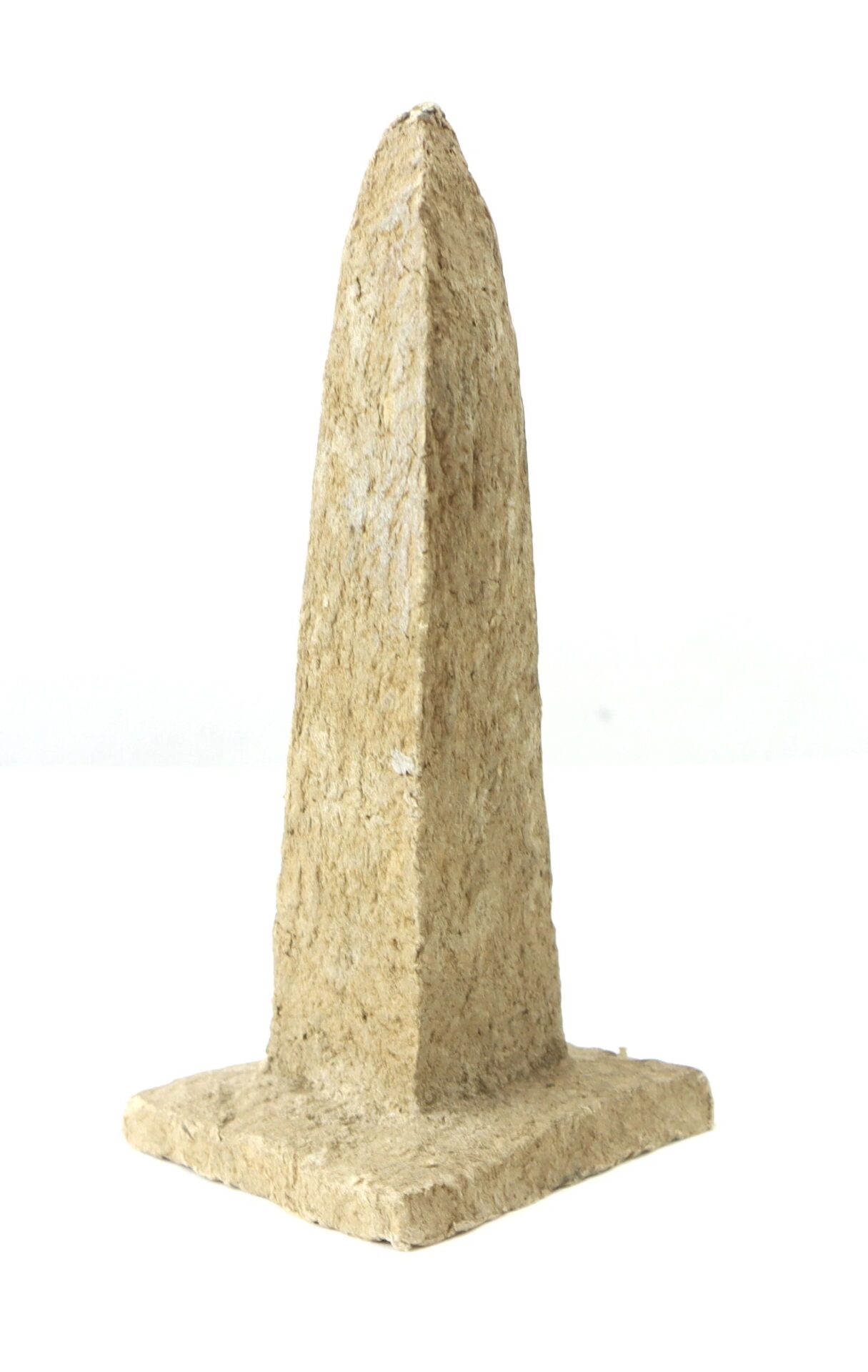 A small, textured, tan Washington Monument replica made from macerated U.S. currency, obelisk-shaped with a square base, displayed against a plain white background.