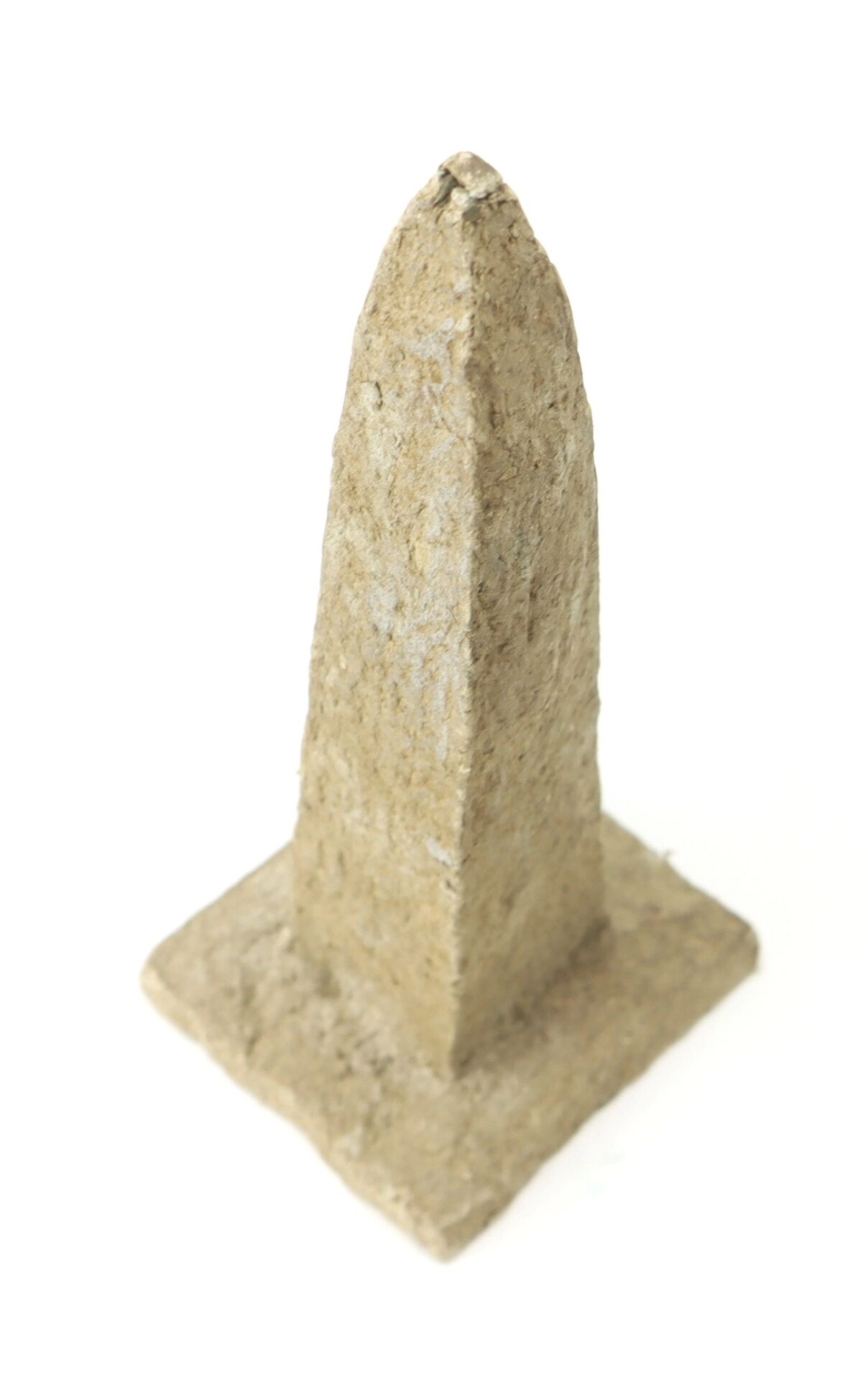 A small, rough-textured obelisk with a square base, made from macerated U.S. currency to resemble the Washington Monument, photographed against a white background.