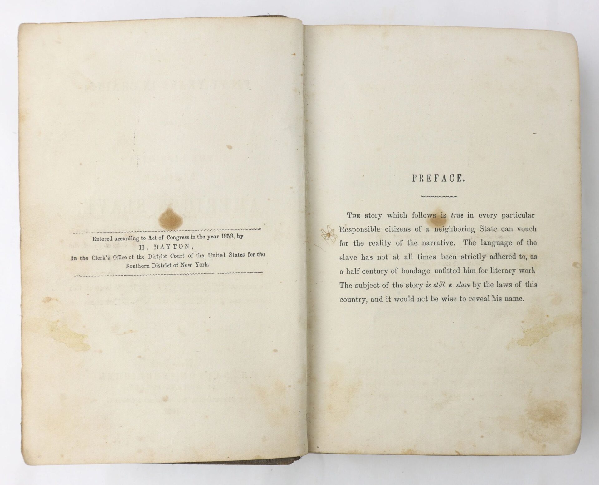 An open book, "Fifty Years in Chains, The Life of an American Slave," shows the copyright page on the left and the preface on the right, both with black text on cream-colored, aged paper.