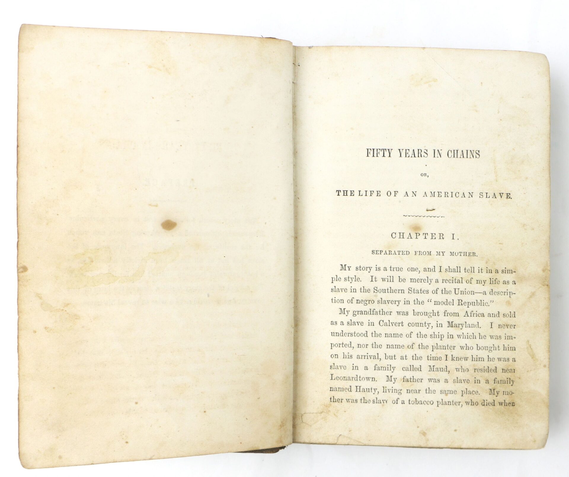 Open book showing the title page and first page of "Fifty Years in Chains, The Life of an American Slave" with visible aged paper and text, beginning Chapter I.