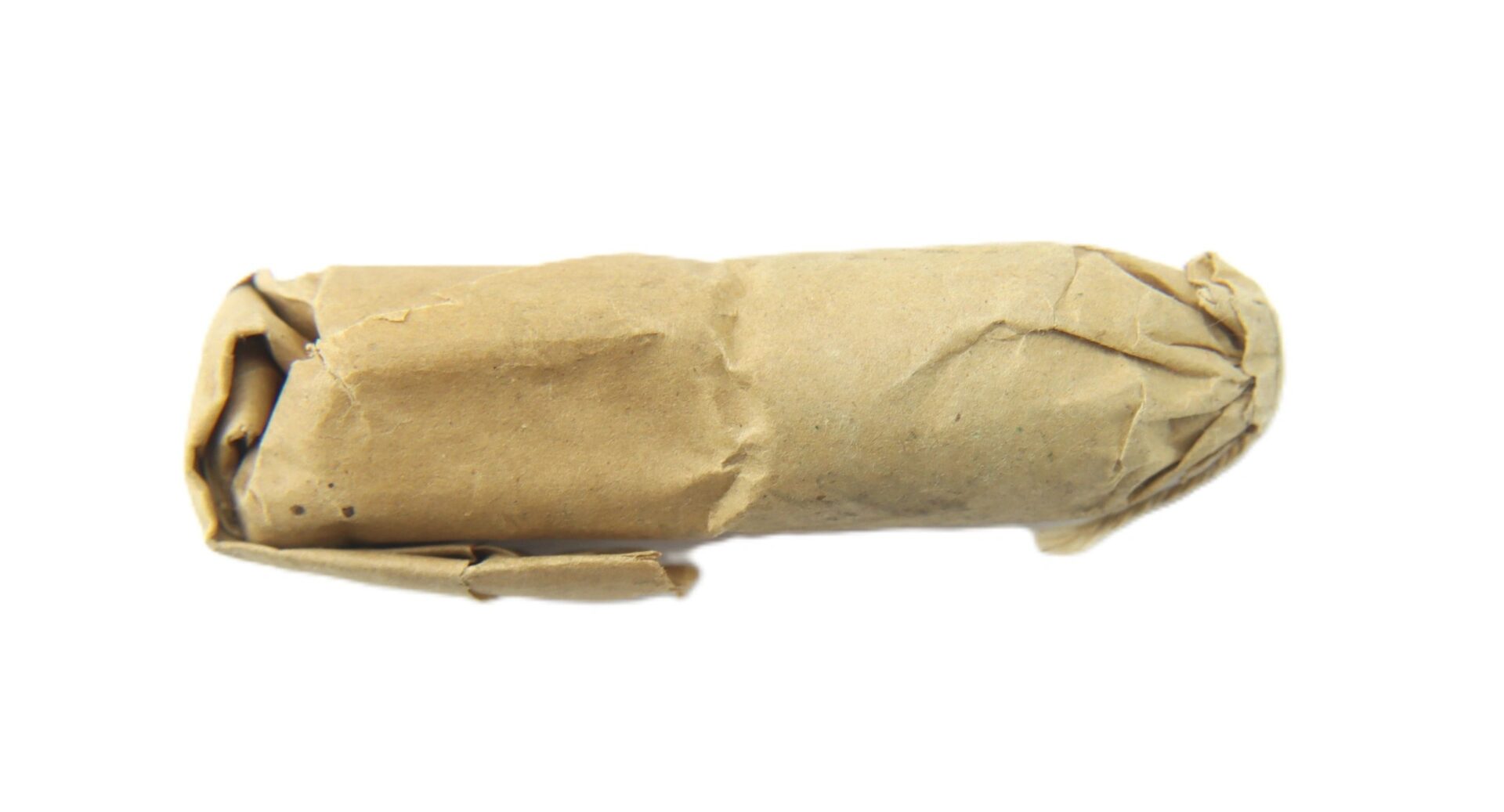A .58 Williams Cleaner Cartridge, cylindrical in shape, is wrapped in plain brown paper and displayed against a white background.
