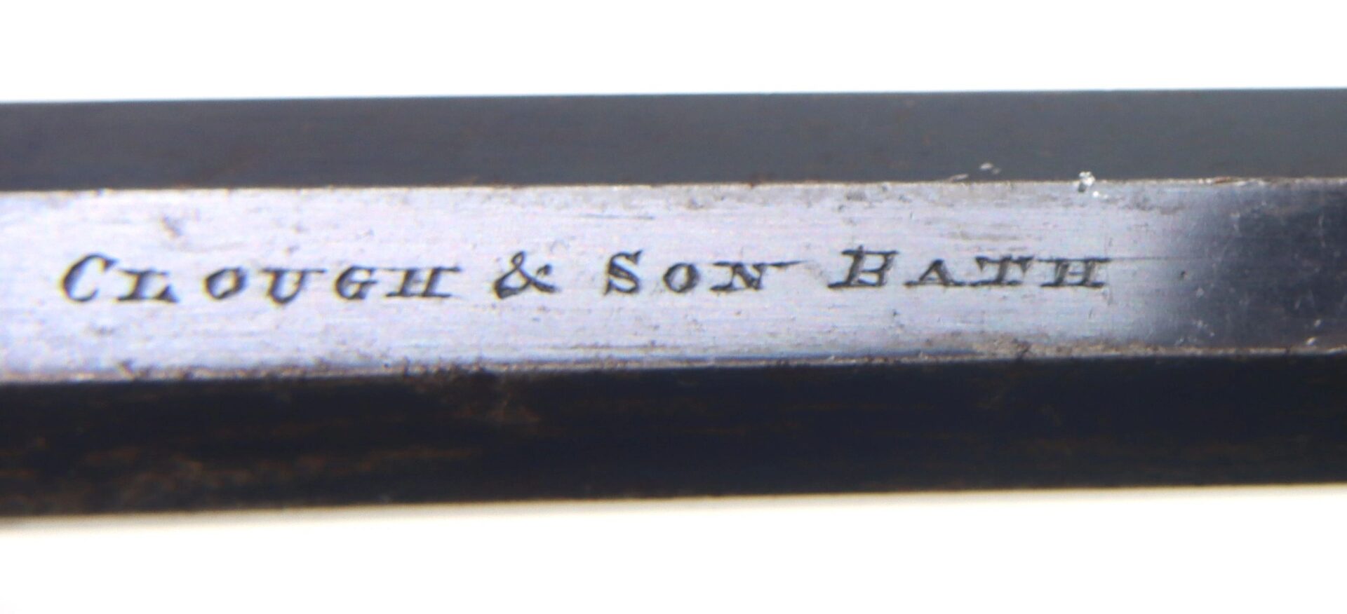 Close-up of a Transitional Revolver by Clough & Son Bath, showing the engraved maker’s mark against a white background.