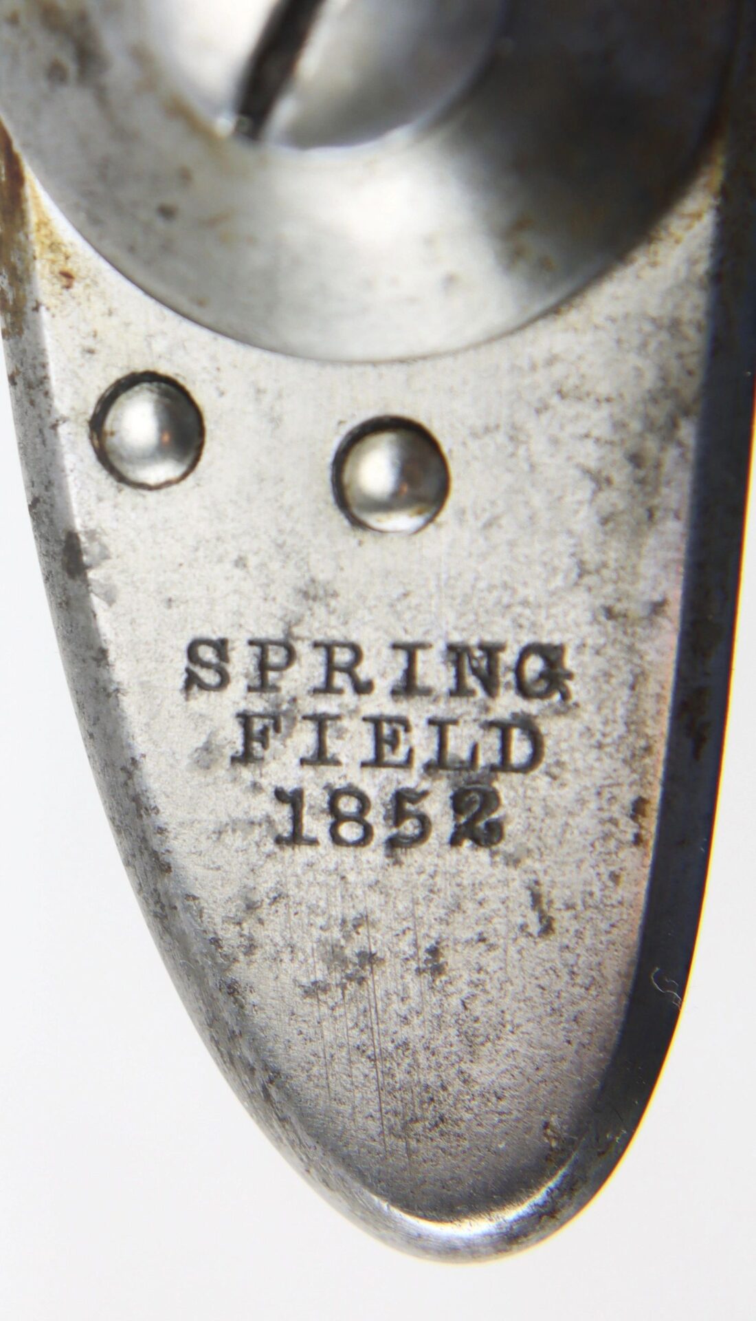 Close-up of a Springfield Model 1842 Lockplate engraved with "SPRINGFIELD 1852" and two rivets visible above the inscription.