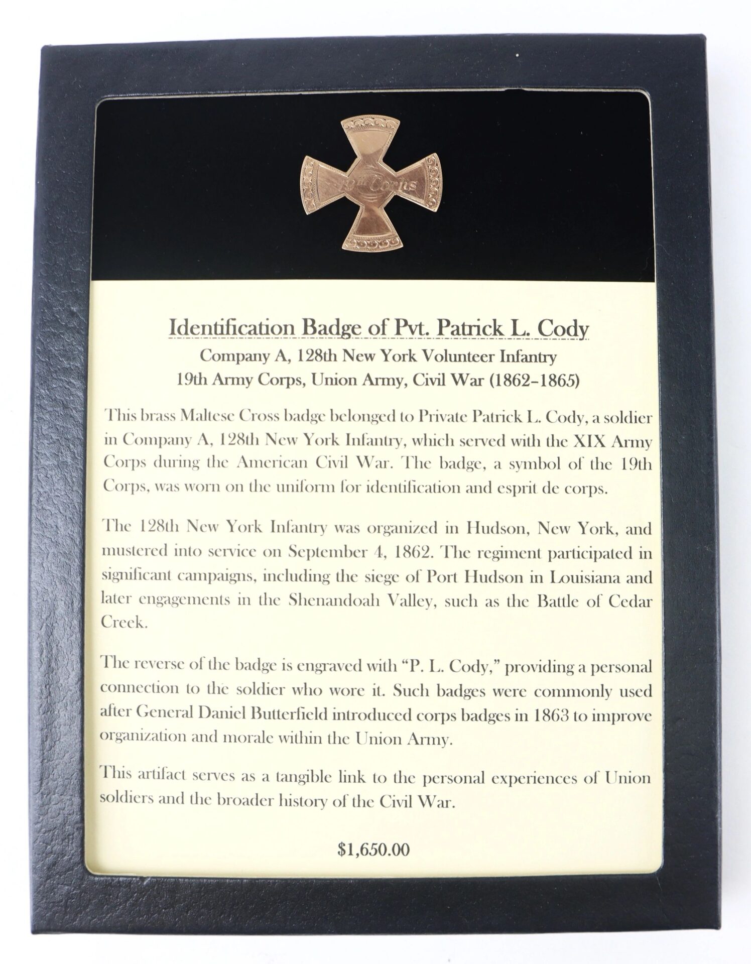Gold identification badge of Pvt. Patrick L. Cody, Company A, 128th New York Volunteer Infantry, 19th Army Corps, Union Army (Civil War, 1862–1865), mounted on a plaque with a label about his service.