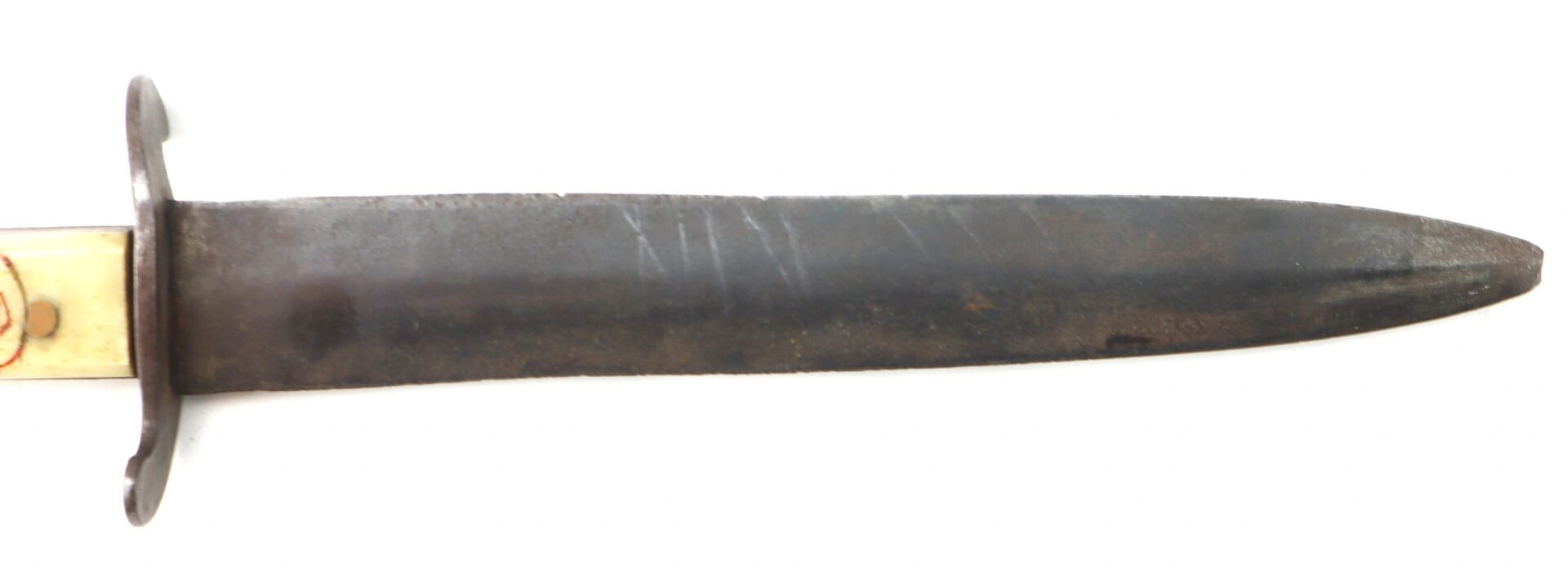 A close-up view of the Scrimshawed Civil War Dagger inscribed to Captain E. S. Jenney, showing its worn double-edged blade with part of the handle and guard visible on the left.