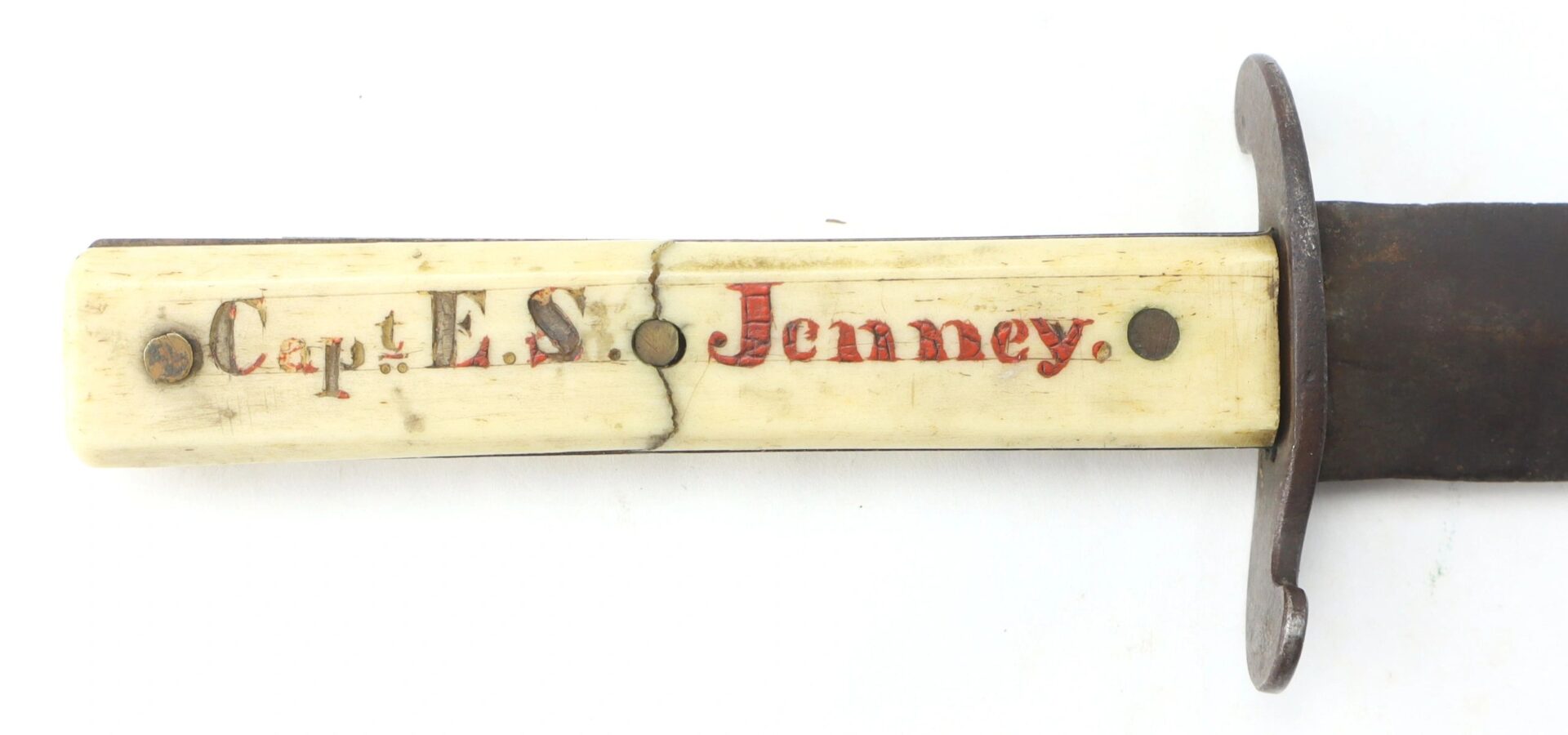 Close-up of the Scrimshawed Civil War Dagger inscribed "Capt. E.S. Jenney" in black and red on the handle, featuring three rivets and a metal guard.