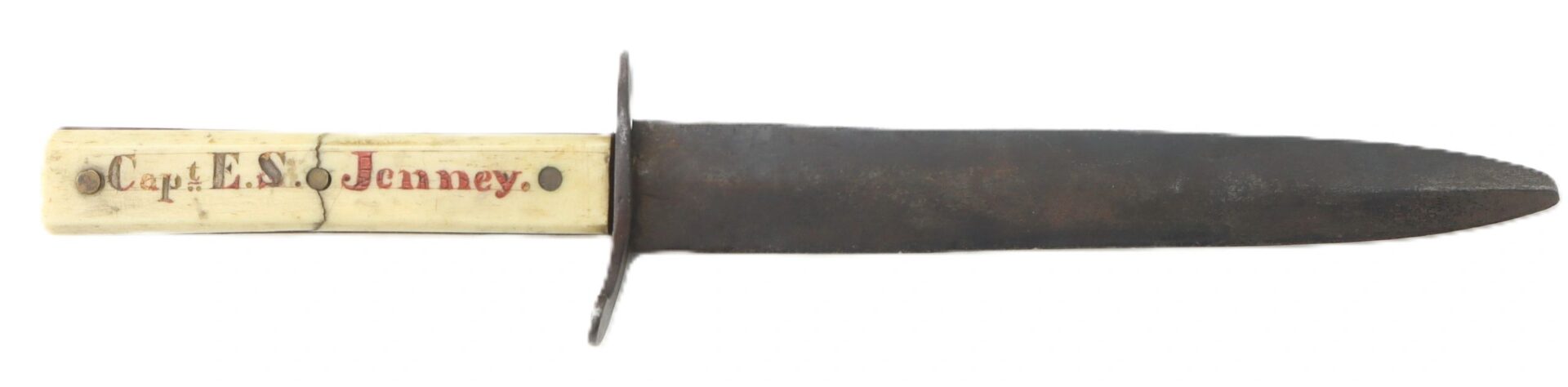 A Scrimshawed Civil War Dagger with a straight, dark blade and handle inscribed with "Capt. E.S. Jenney" in red and black lettering.