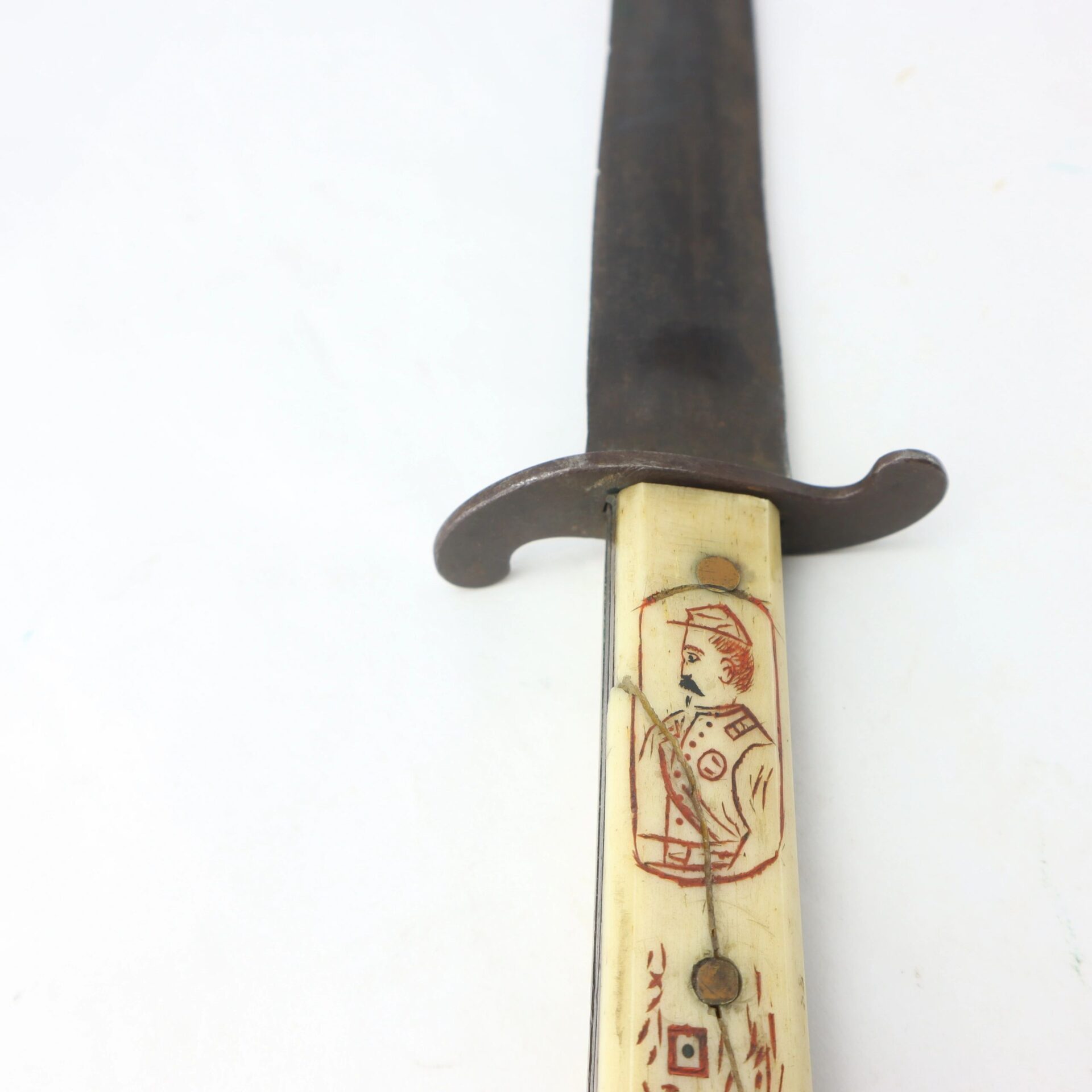 A Scrimshawed Civil War Dagger inscribed to Captain E. S. Jenney, featuring a dark blade and a handle etched with the portrait of a uniformed officer.