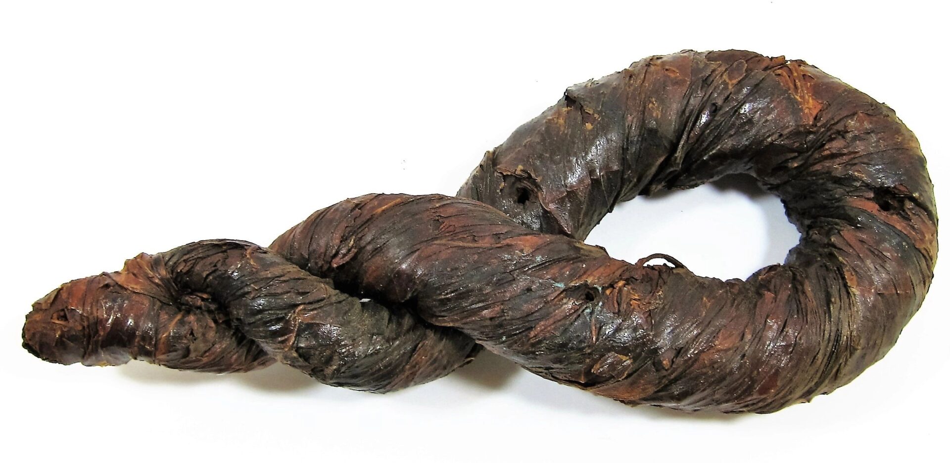 A large, dark brown Tobacco Twist, spiral-shaped and displayed on a white background. SOLD.
