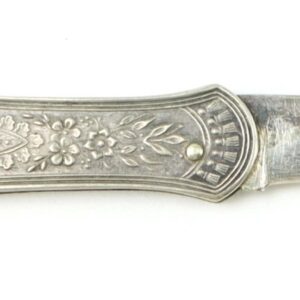 A Victorian sterling or silver-plated folding fruit knife with an ornate floral design, displayed against a white background.