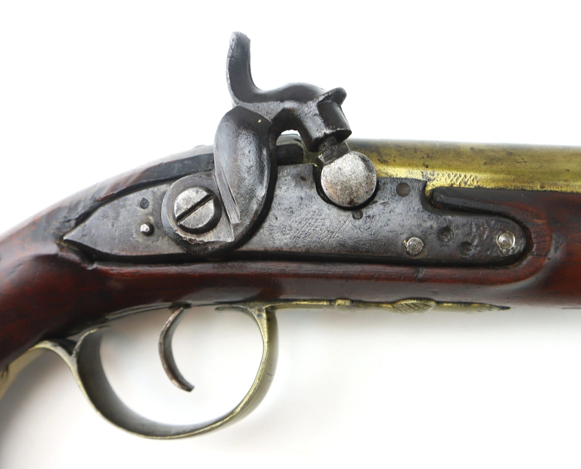 Close-up of the lock mechanism on the English Pistol with Brass Barrel and Grotesque Mask Butt Cap, showing wood, brass, and iron components.