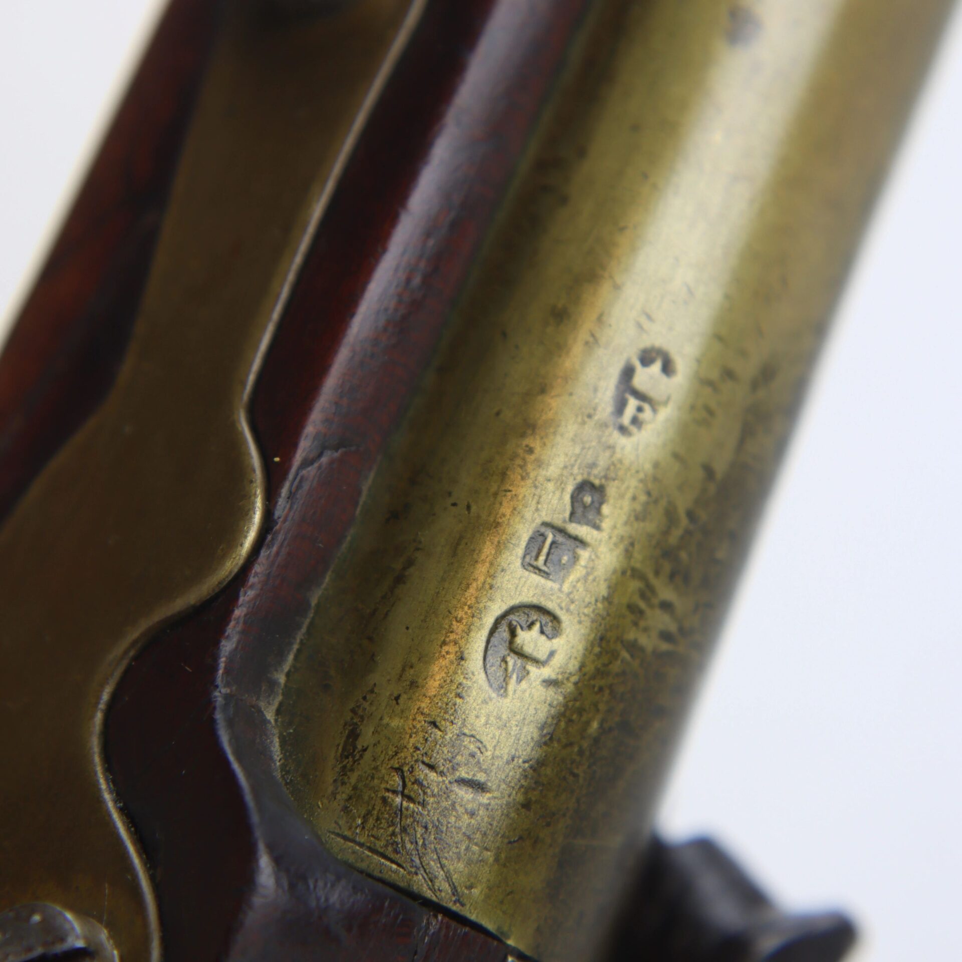 Close-up of the brass barrel section on an English Pistol with Brass Barrel and Grotesque Mask Butt Cap, showing stamped proof marks.