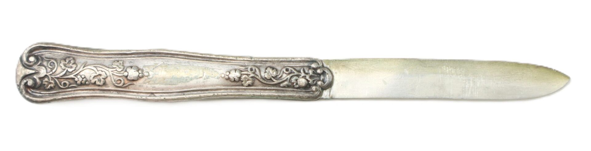 A vintage British sterling silver folding fruit knife featuring a floral repoussé handle and a plain, slightly tarnished blade.
