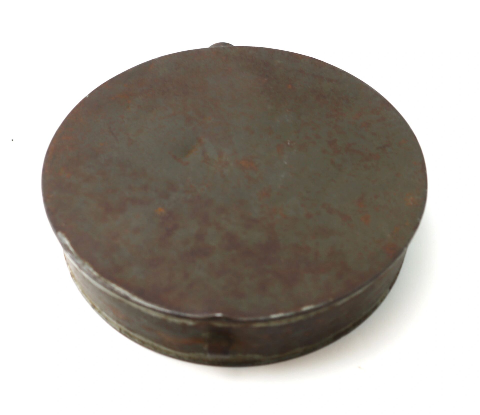 A round, flat Civil War Tin Drum Canteen made of metal with a fitted lid, displaying rust and surface wear.