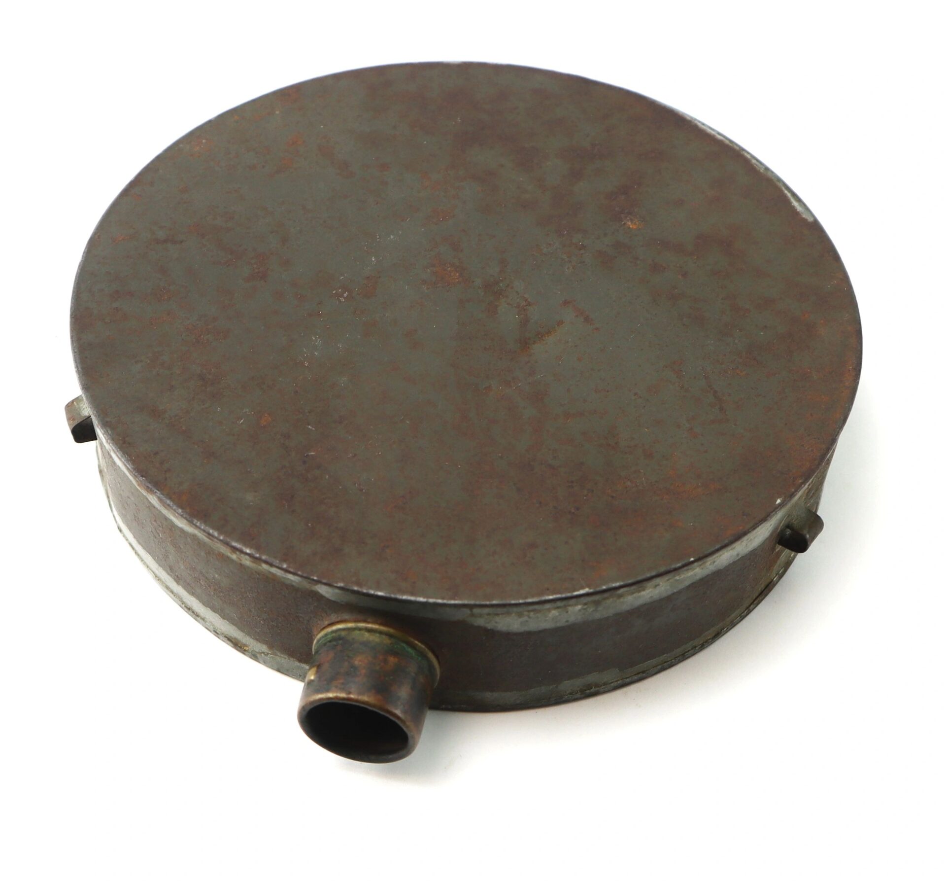 The Civil War Tin Drum Canteen is a round, flat, rusted metal container featuring a small cylindrical spout on its side, shown against a white background.