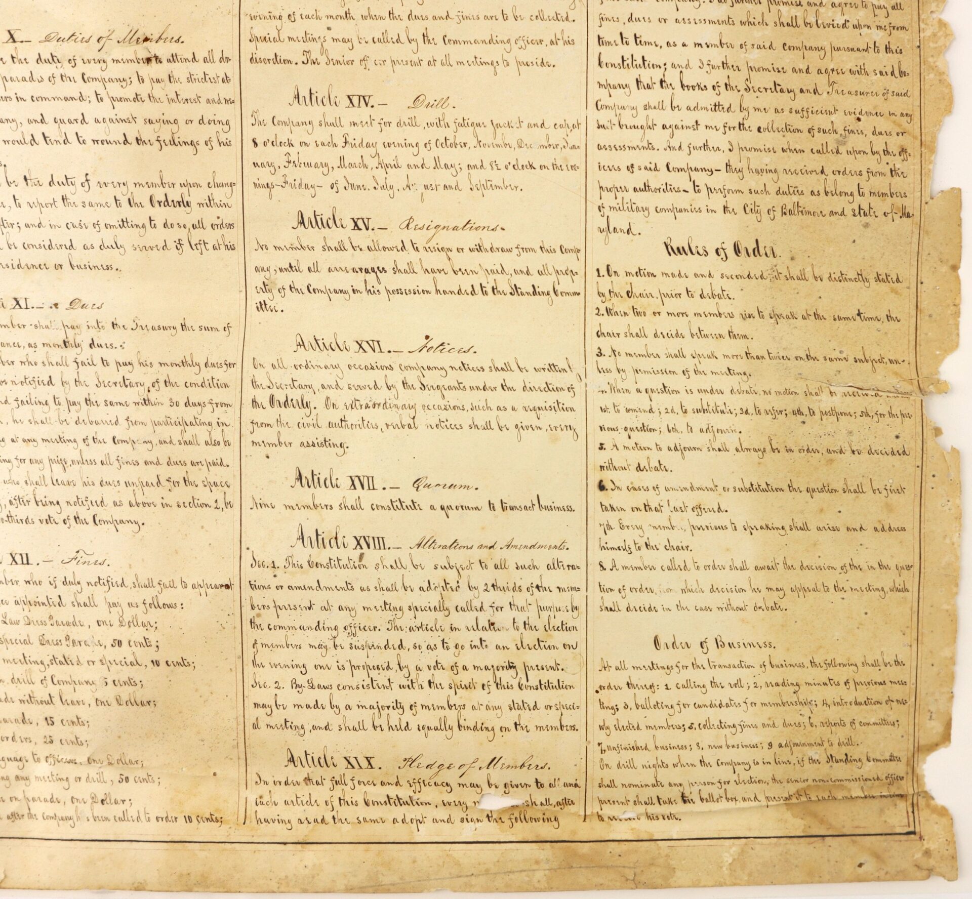 Aged manuscript page from "Constitution and Laws of the Baltimore City Union Guards" (Baltimore, c. 1860s) features handwritten text in neat cursive columns listing articles and sections on yellowed paper.