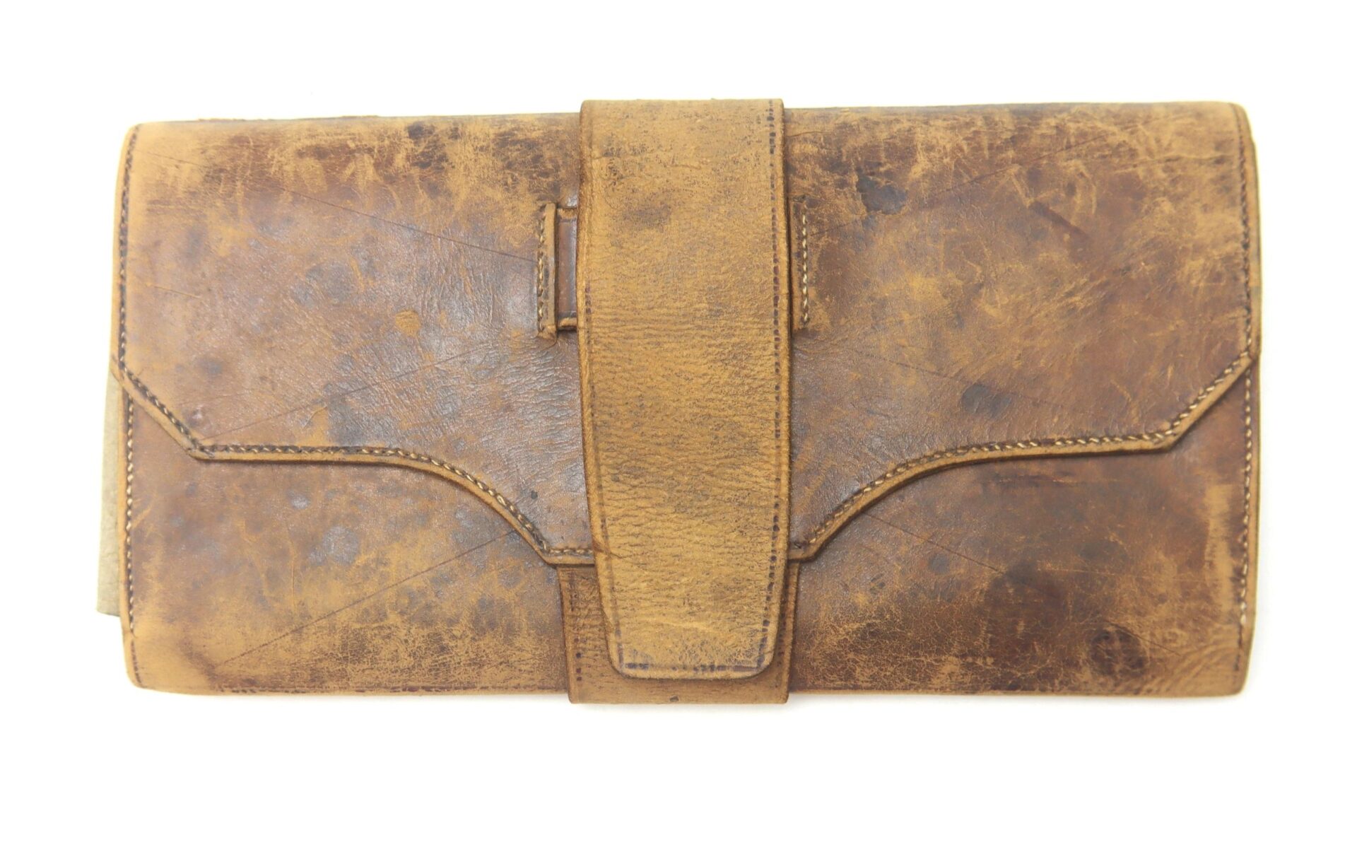An antique brown leather wallet from 1846 with a large front flap and visible creases, displayed on a white background.