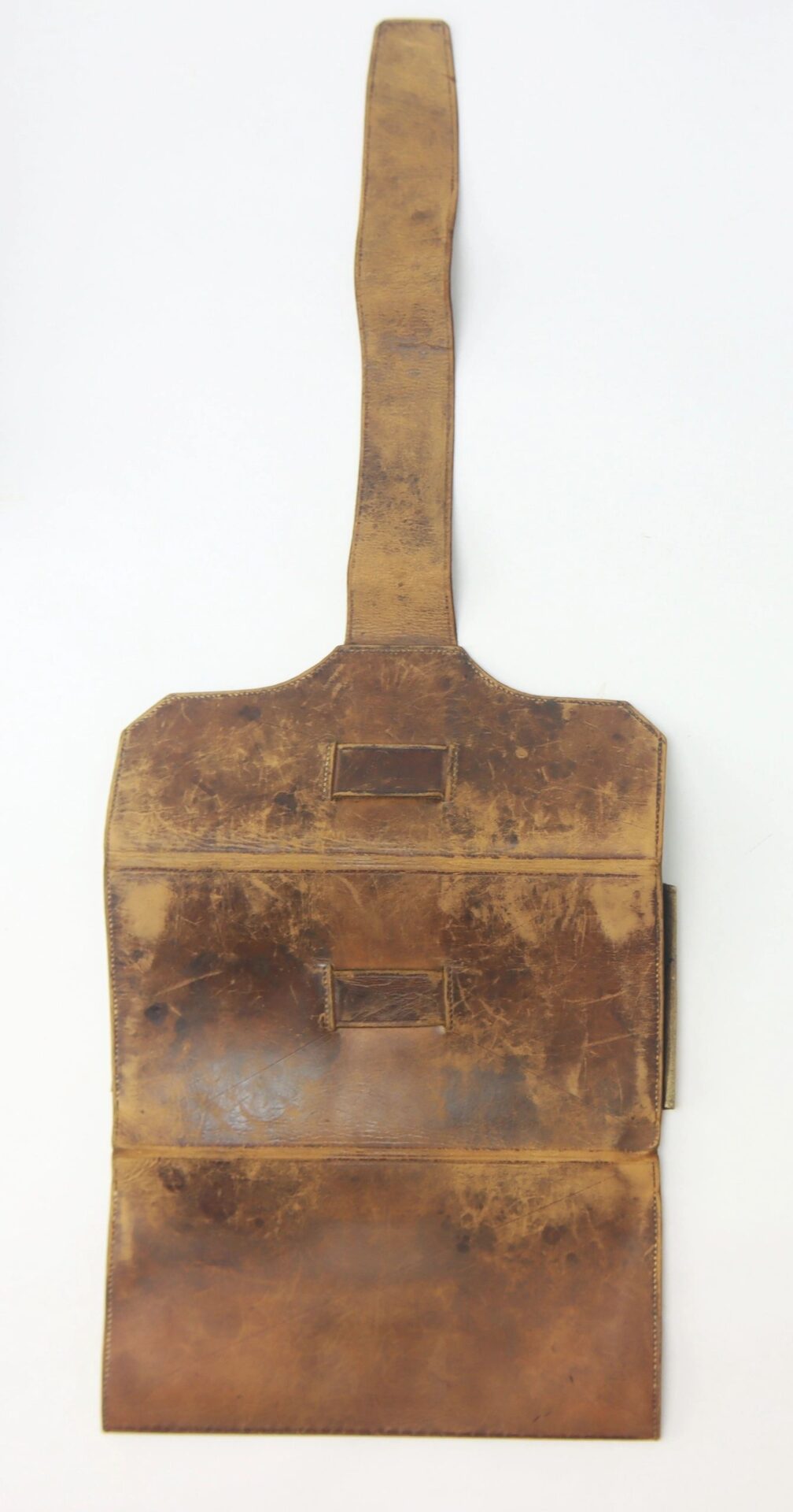 A worn brown Leather Wallet (Dated 1846) with a long flap and two rectangular patches is shown open against a white background.