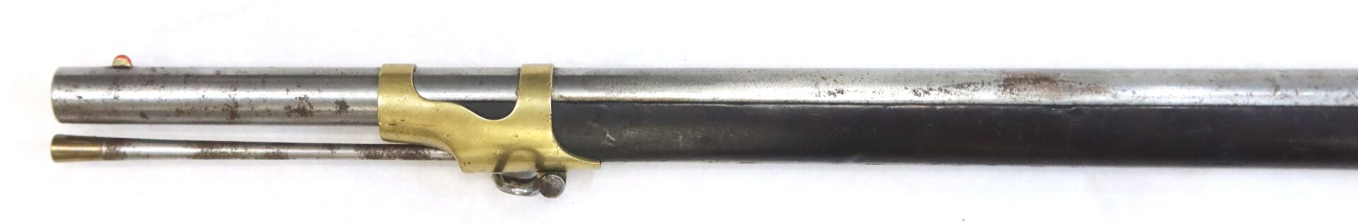 Close-up of the barrel and ramrod of an antique muzzle-loading rifle with a brass barrel band on a white background.